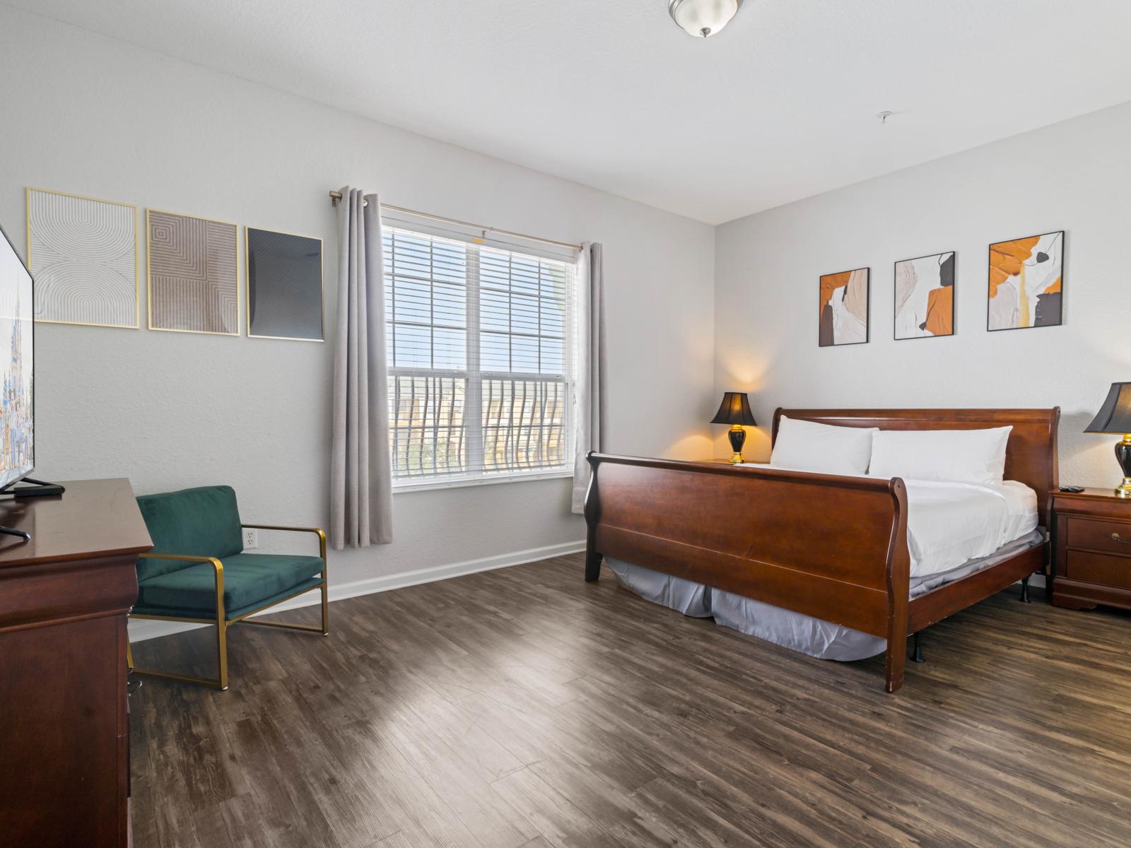 - Spacious bedroom, featuring a beautiful bed for a restful night’s sleep - Room is adorned with stylish decor, hardwood floors, & large windows inviting natural light - Equipped with modern comforts, this space is your sanctuary to unwind