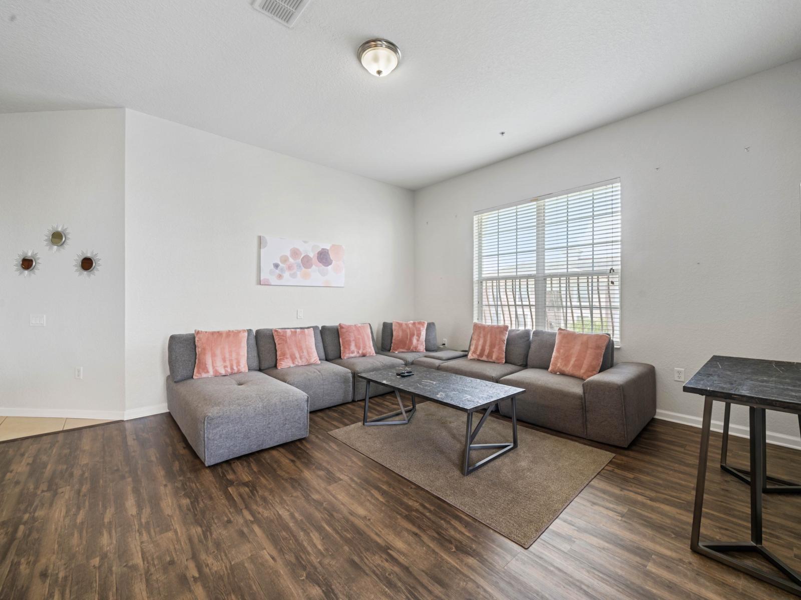 - Spacious living room featuring a large, comfortable sectional sofa for everyone - Large windows let in plenty of natural light, creating a bright & inviting ambiance allthe day - Perfect space for family movie nights or unwinding with a good book