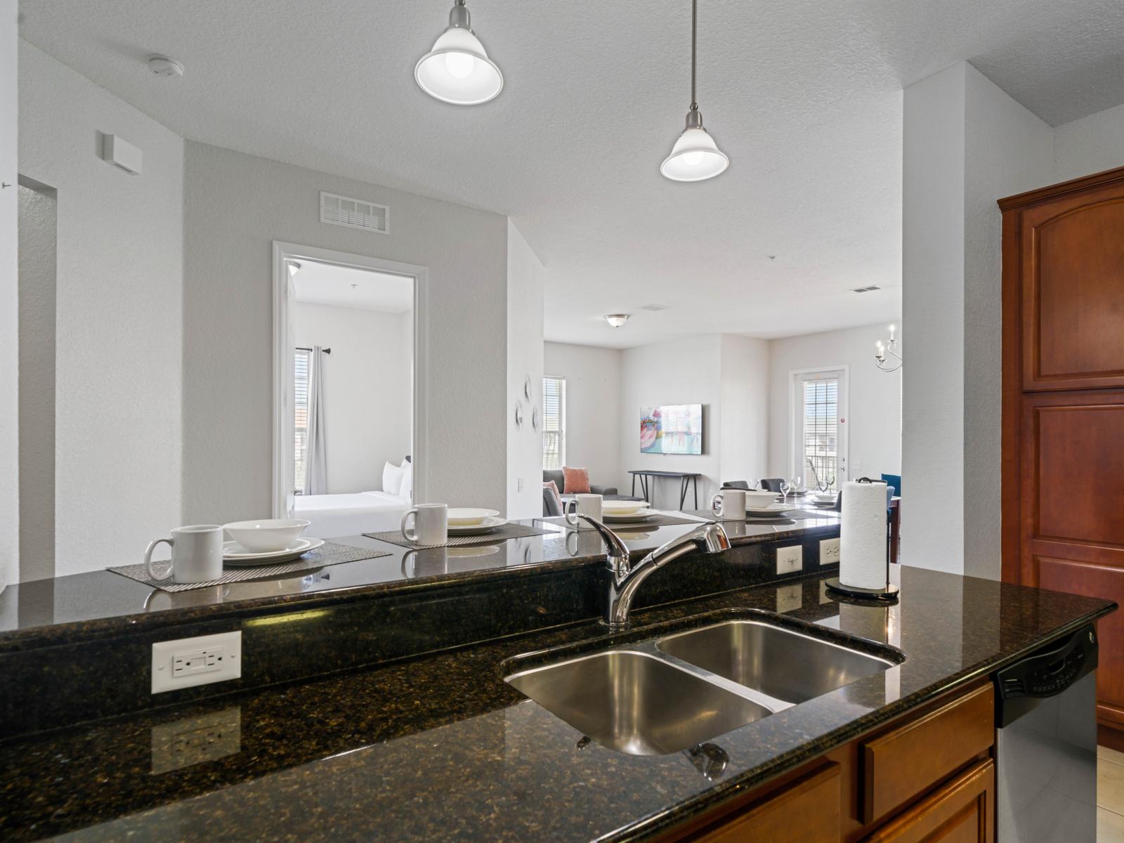 - Sleek granite countertops with a double sink and modern fixtures for all your culinary needs - Open-concept design, offering views into the living & dining areas while you cook - Spacious, ensuring a comfortable & functional workspace for meal prep