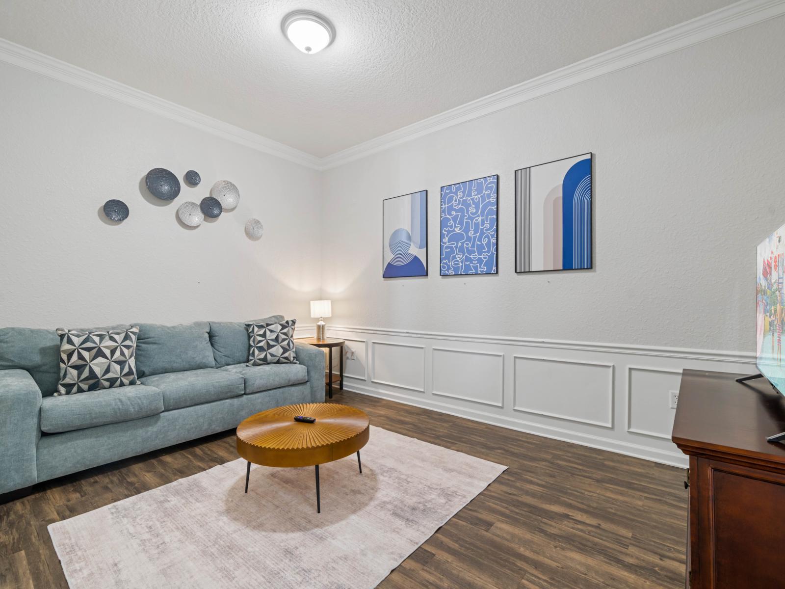 - Comfortable lounge, featuring a plush sofa and stylish decor - Adorned with modern wall art & warm lighting, this is a great spot for unwinding up on your favorite shows - Charming, intimate space ideal for casual conversations or quiet evenings in