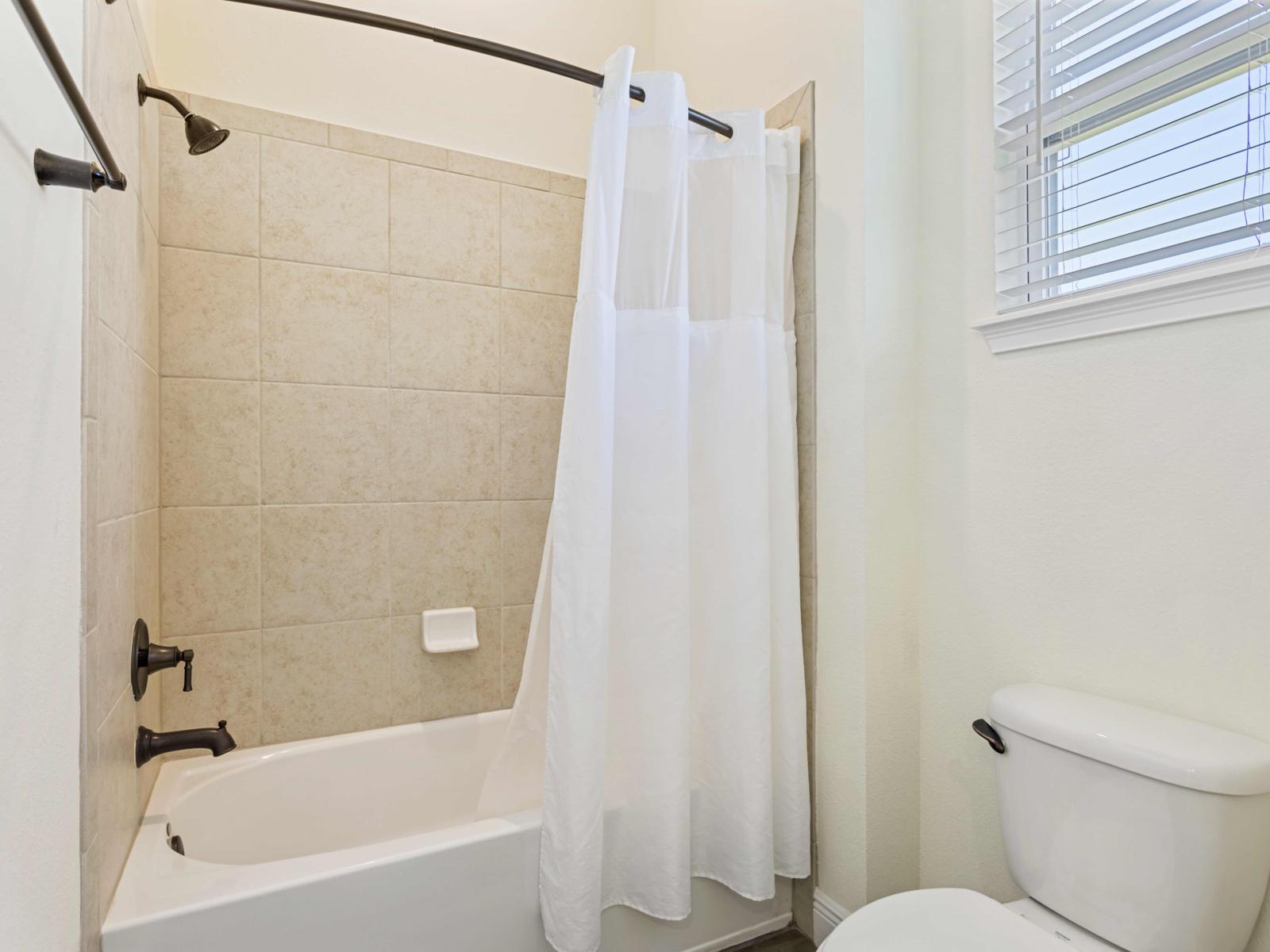 Bathroom 2 with a bathtub and shower combination