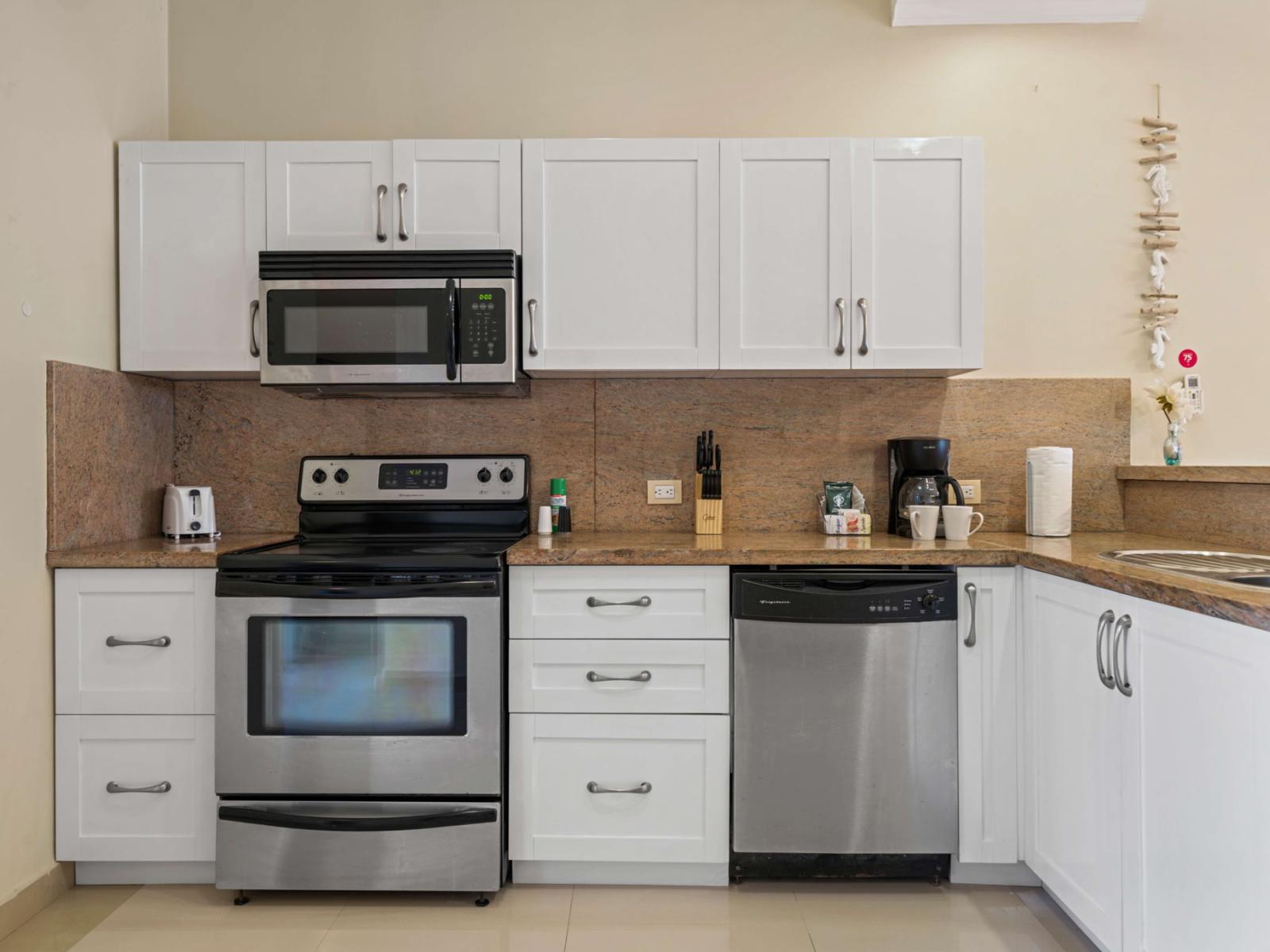 A bright and inviting kitchen with modern appliances, ample storage cabinets, and a front-facing pool view that fills the space with natural light is perfect for a booking retreat!