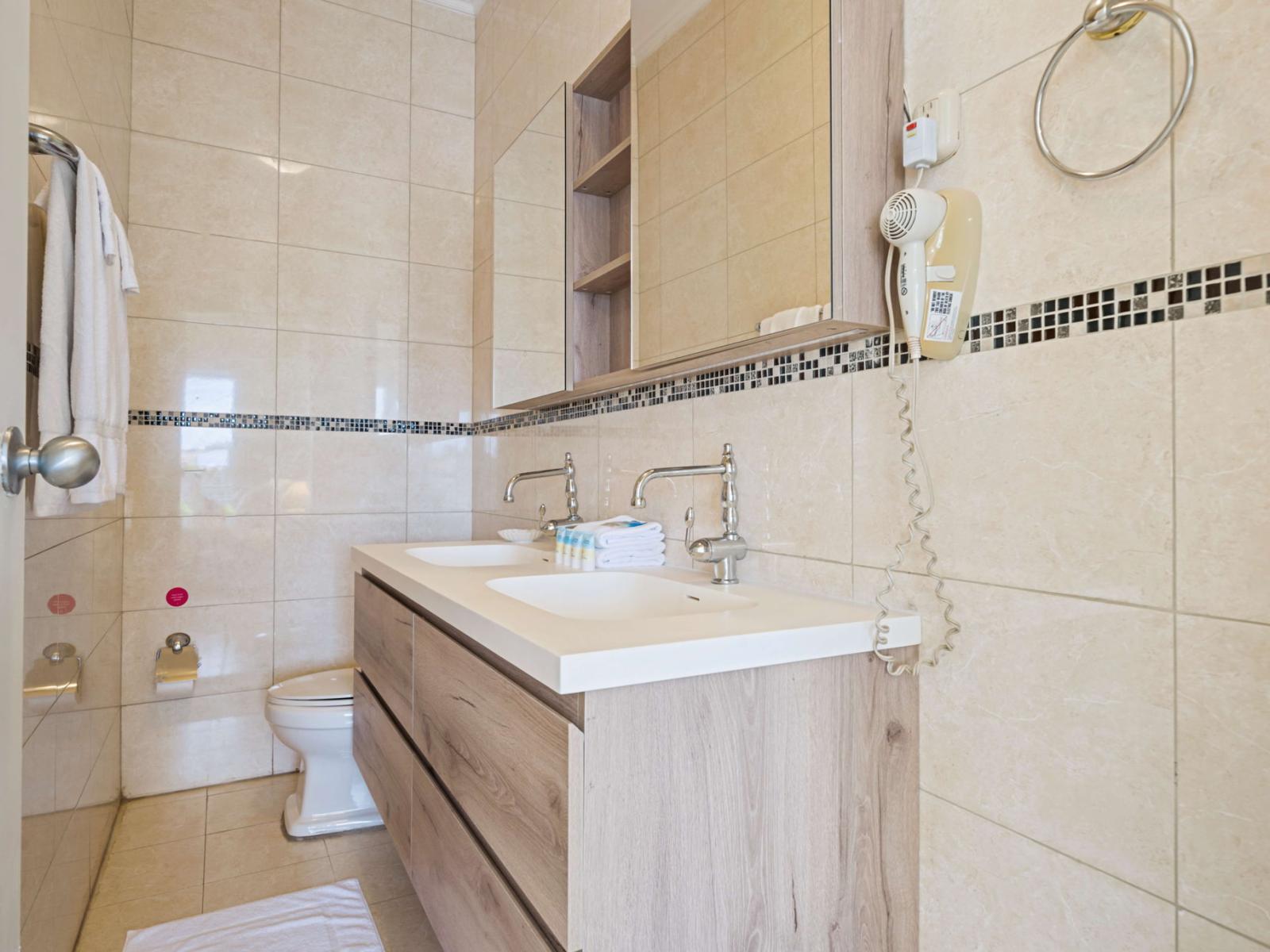 Bathroom 1 with a walk in shower and double sinks