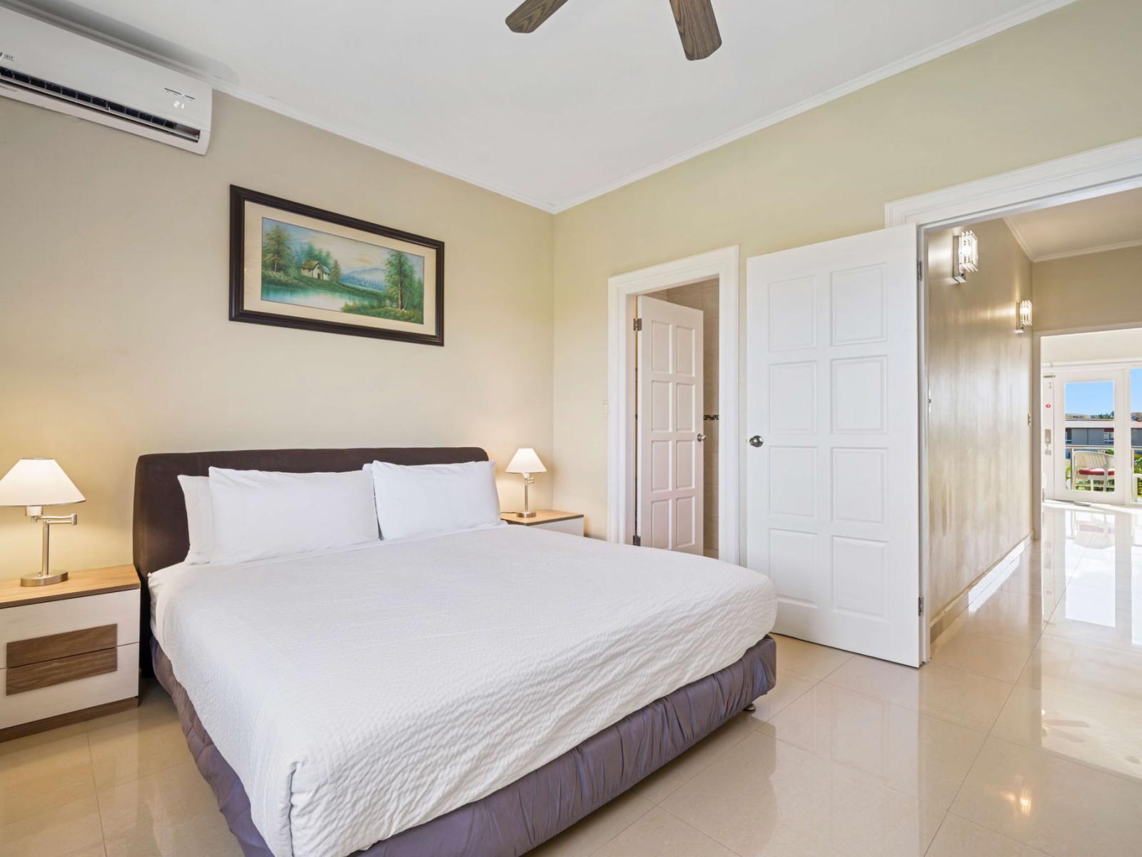 Relax in the luxurious second bedroom with a king-sized bed, smart TV, ensuite bathroom, and a window view that fills the space with natural light – the perfect Airbnb retreat!