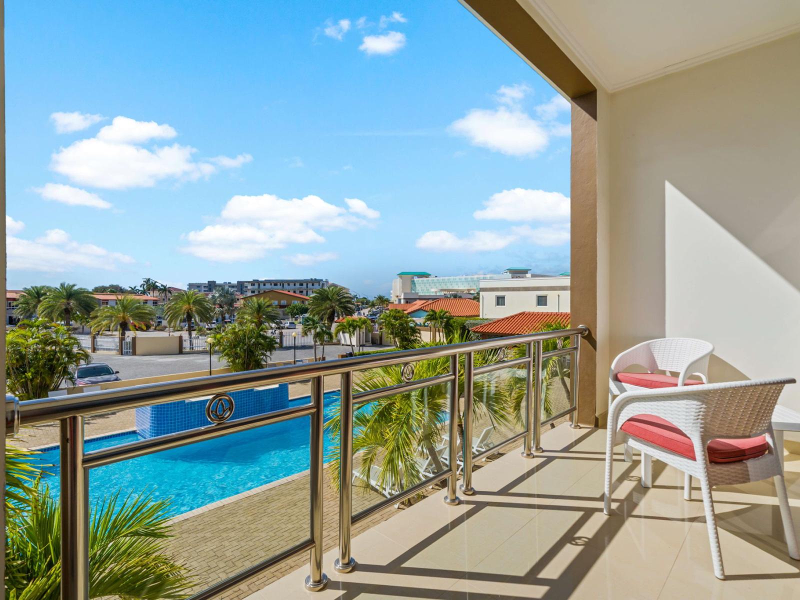 Balcony with pool view and lounge chairs