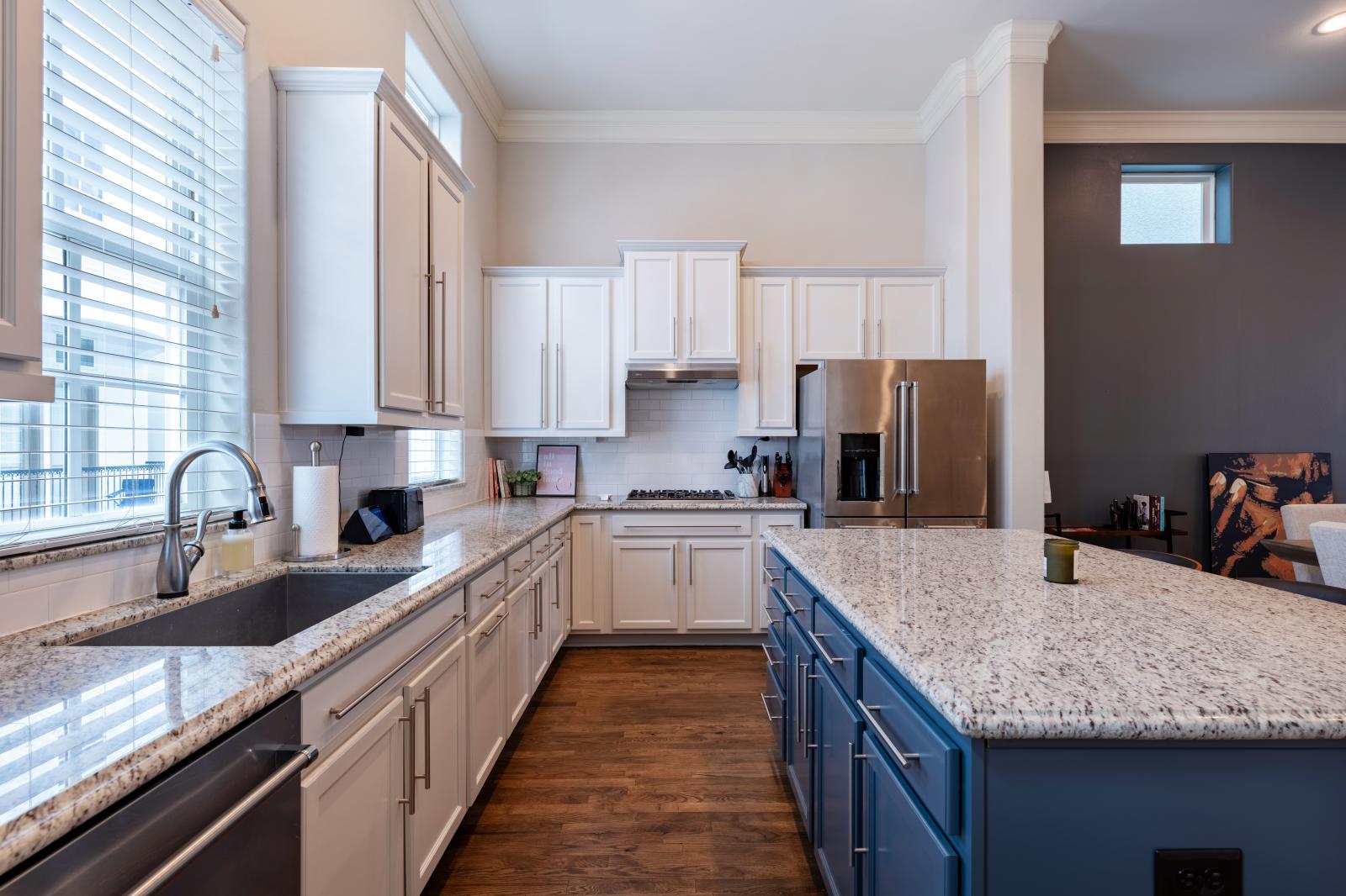 Bright and modern kitchen with high-end appliances, ample natural light, and elegant finishes. Enjoy a spacious layout with large windows, sleek countertops, and top-tier stainless steel appliances—perfect for cooking and entertaining in style!