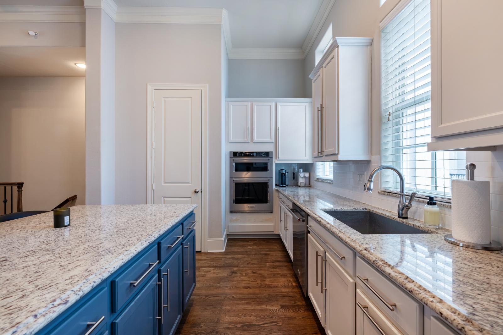 A built-in oven with convection microwave, high-end dishwasher, sleek coffee maker, and a spacious walk-in pantry.