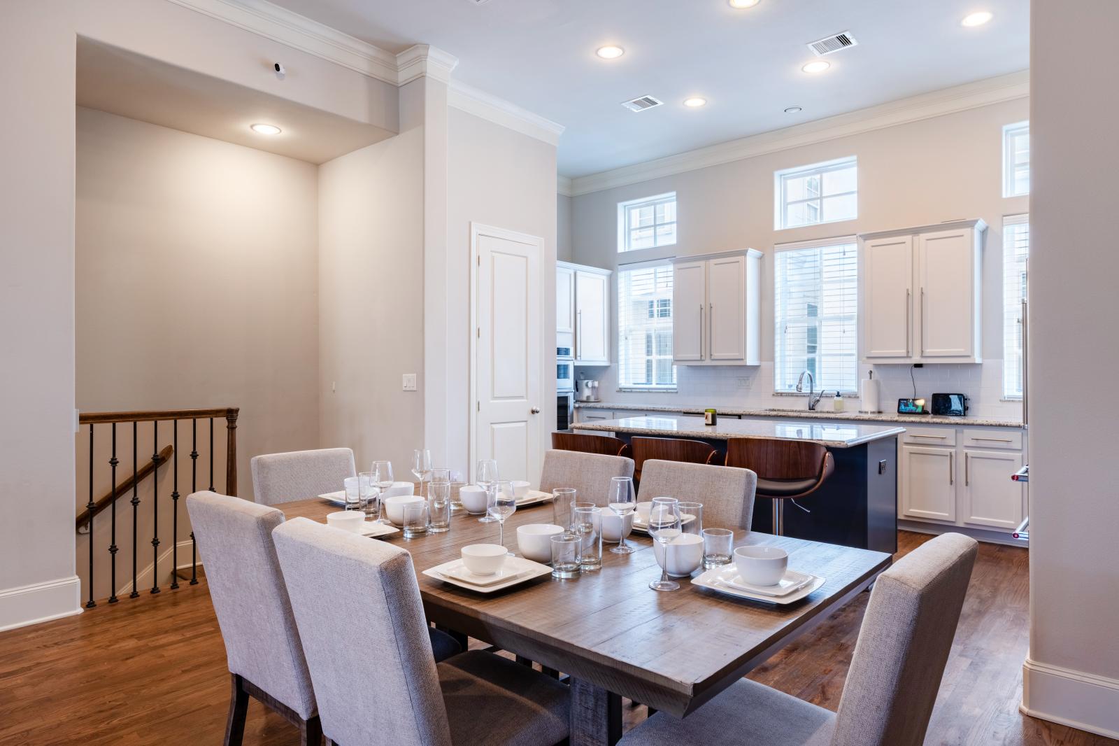 Elegant dining area with seating for six, perfectly situated between the open-concept kitchen and main living room. Enjoy a welcoming space ideal for shared meals or entertaining.