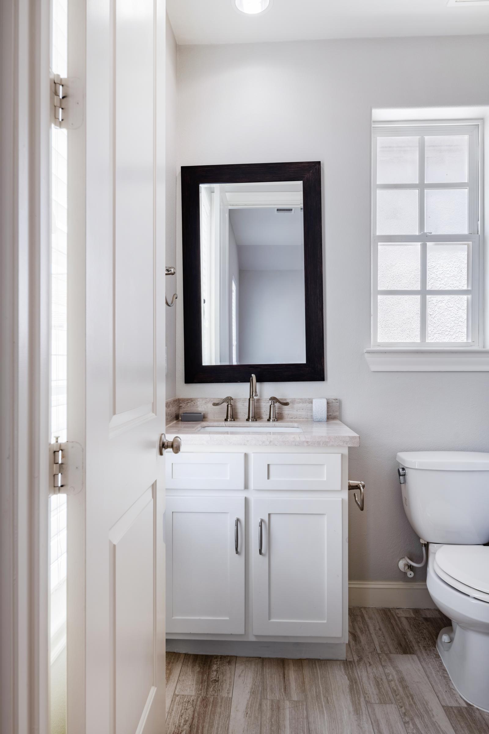 Bedroom 2 features an en-suite with a modern decor and  bright vanity