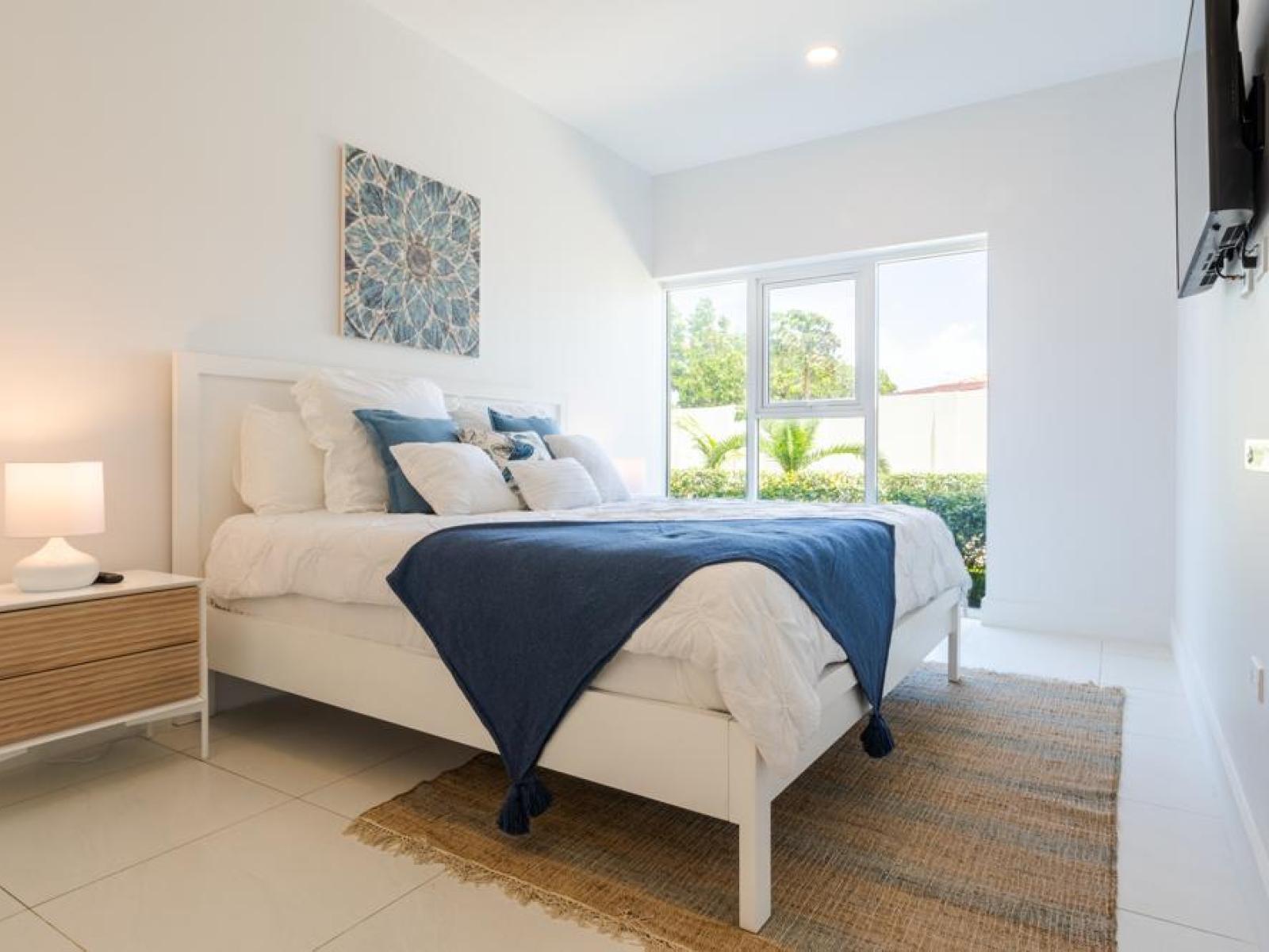 Bedroom 1 has big sleek windows for natural light