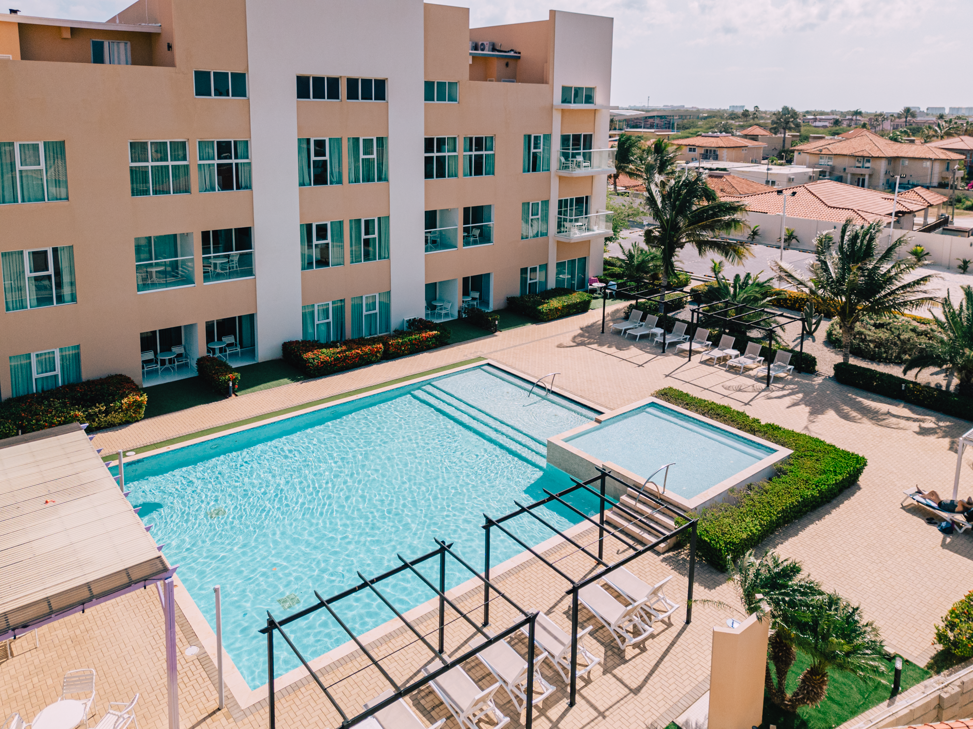 A stunning aerial view of a poolside oasis surrounded by modern residences.