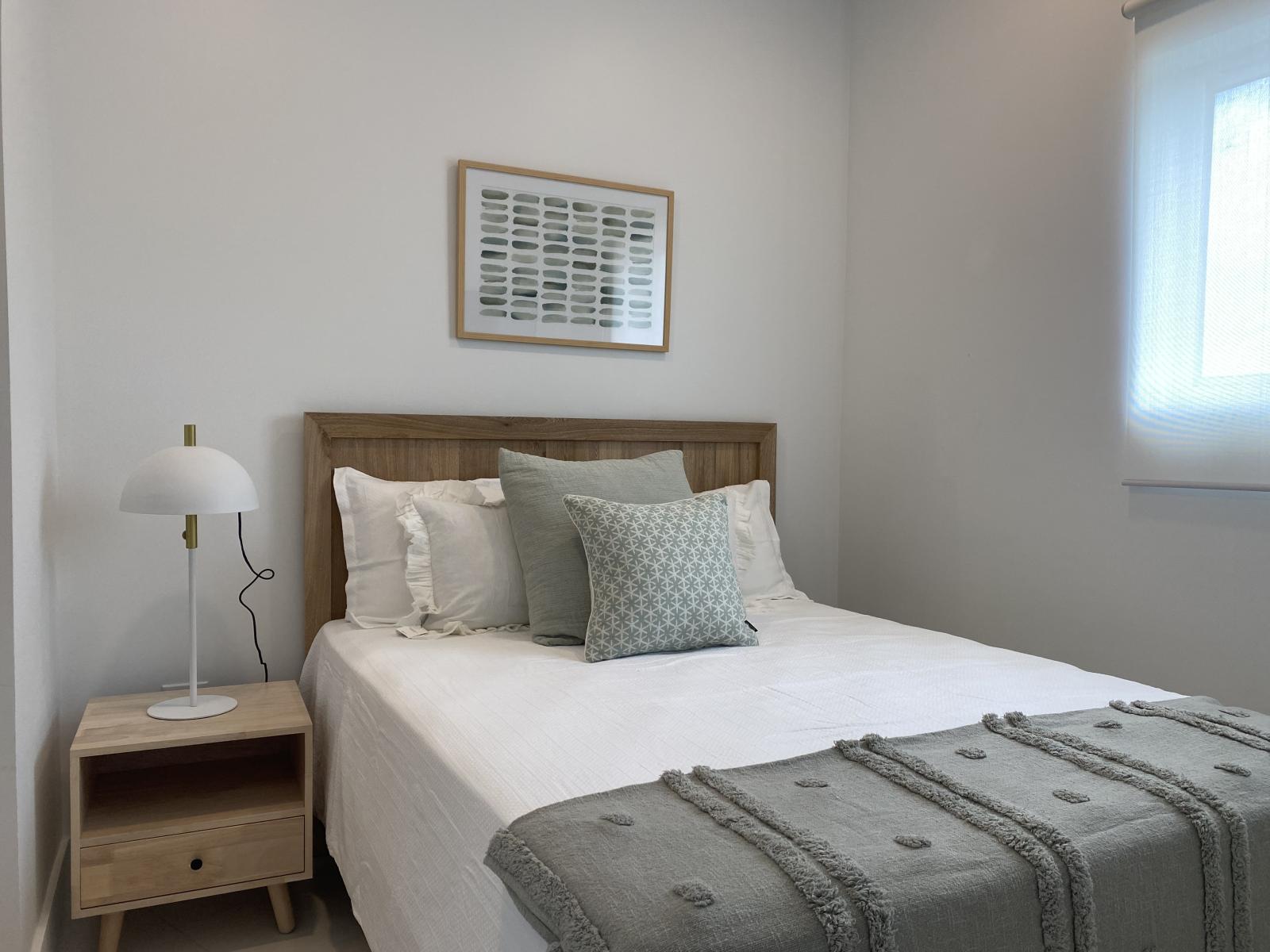 Comfort in this stylish bedroom with a dreamy queen sized bed - Thoughtfully designed with soft tones, plush pillows, and serene vibe, perfect for relaxation - Whether it's a restful night or a lazy morning, this space is your personal retreat