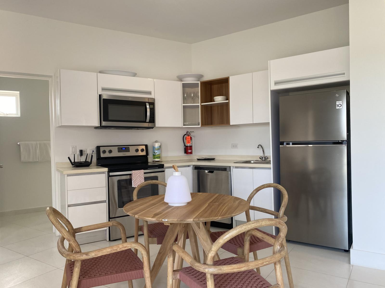 Fully equipped kitchen with modern appliances, perfect for home cooked meals - Enjoy your morning coffee at the cozy dining table or prepare a feast with ease - Bright, spacious, and functional, your ideal home away from home kitchen setup