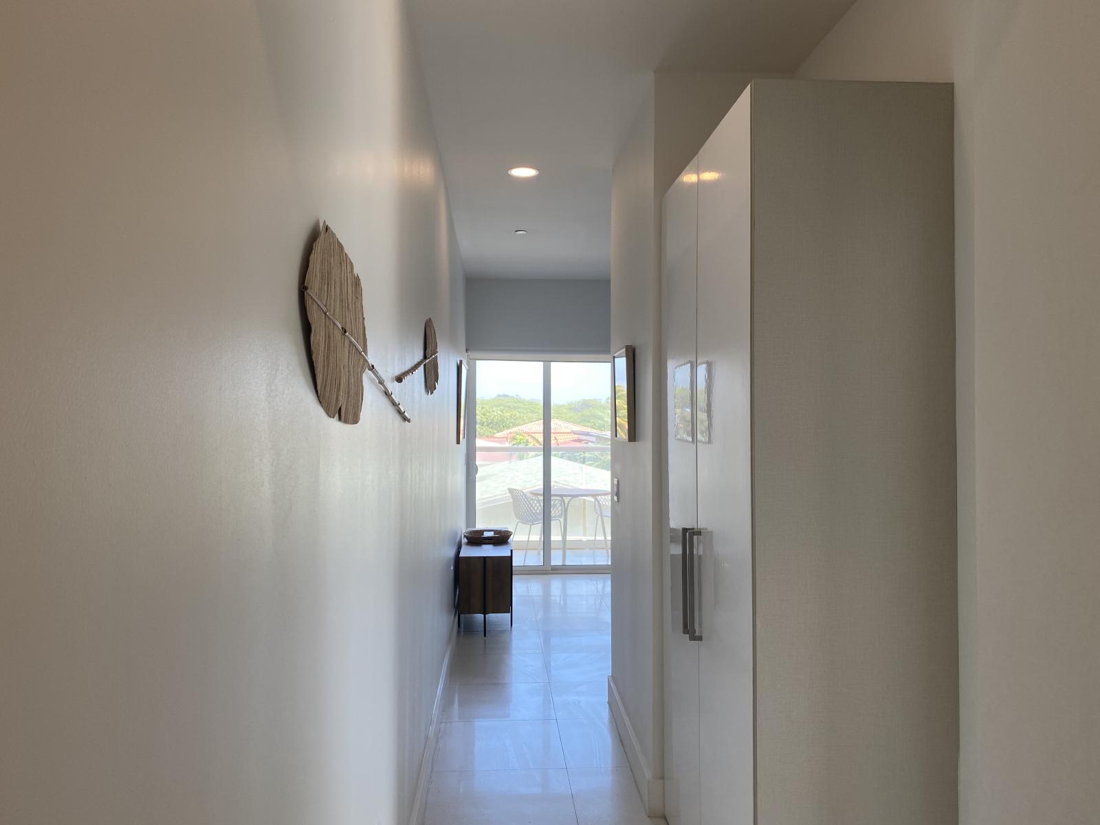 Bright and airy hallway, leading you to a stunning sunlit balcony with breathtaking views - Thoughtfully designed with sleek finishes for a modern and welcoming feel - Natural light enhances the open, spacious ambiance, making every step inviting