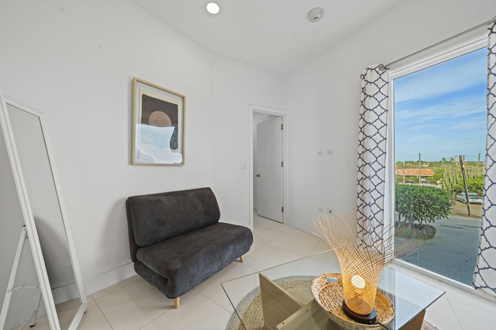 Modern lounge corner where style meets comfort, perfect for unwinding - Sip your morning coffee, journal or simply relax in this peaceful & elegant space - Thoughtfully designed with cozy textures & warm natural accents, it’s your personal retreat