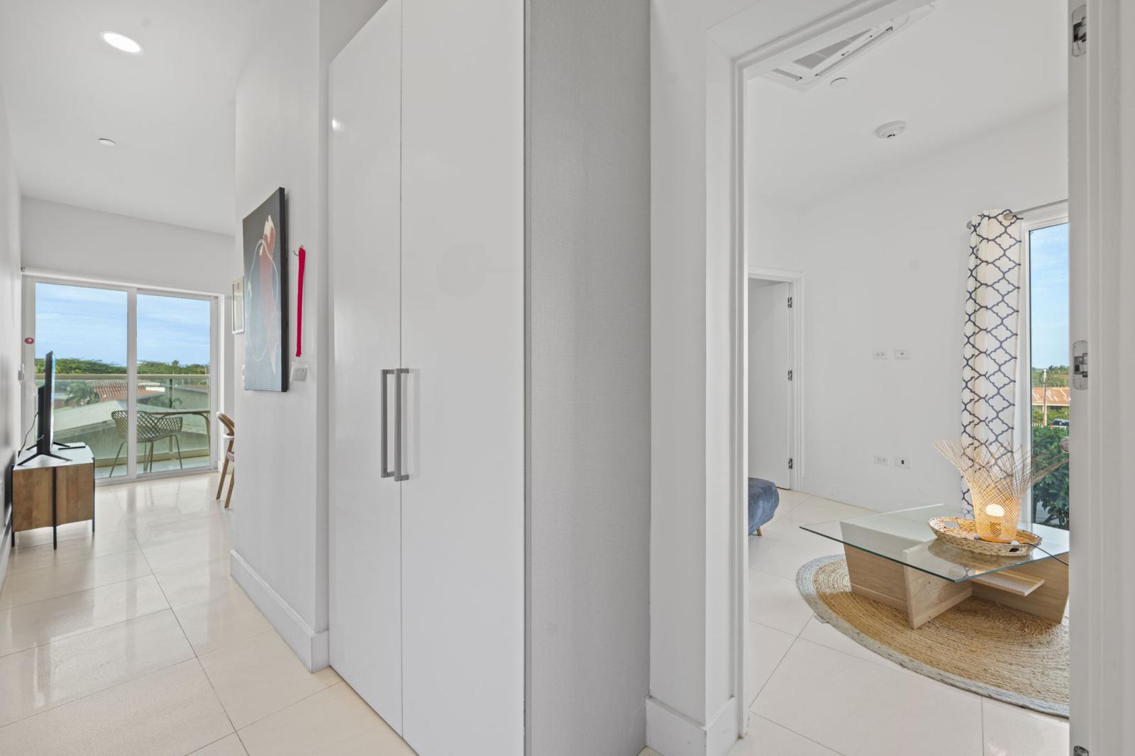 Bright and airy hallway, leading you to a stunning sunlit balcony with breathtaking views - Thoughtfully designed with sleek finishes for a modern and welcoming feel - Natural light enhances the open, spacious ambiance, making every step inviting
