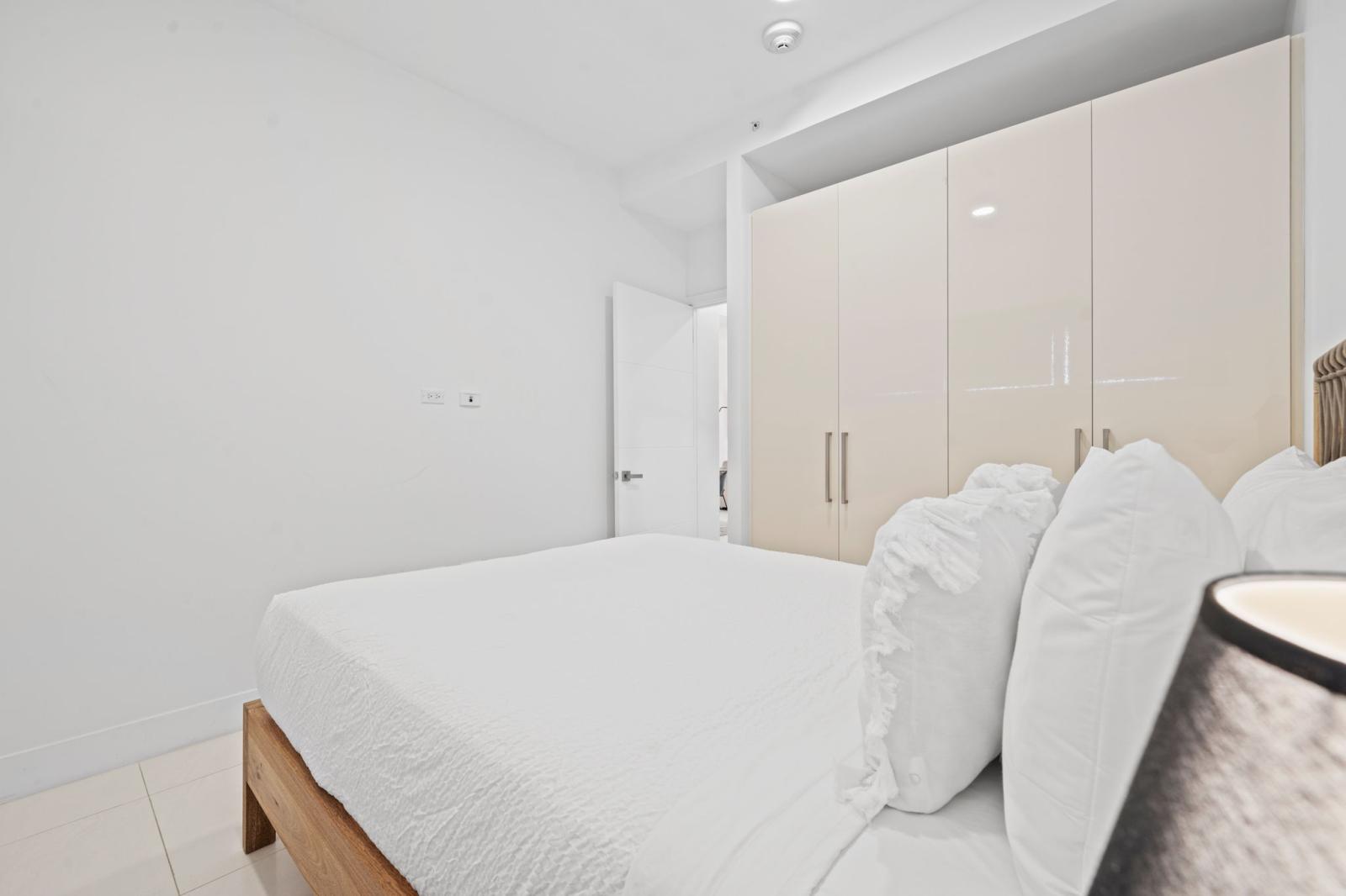 Drift into a peaceful slumber on this inviting queen size bed with ultra soft linens - Thoughtfully designed with coastal inspired decor, bringing a fresh vibe - Cozy retreat made for relaxation, where comfort and style come together beautifully
