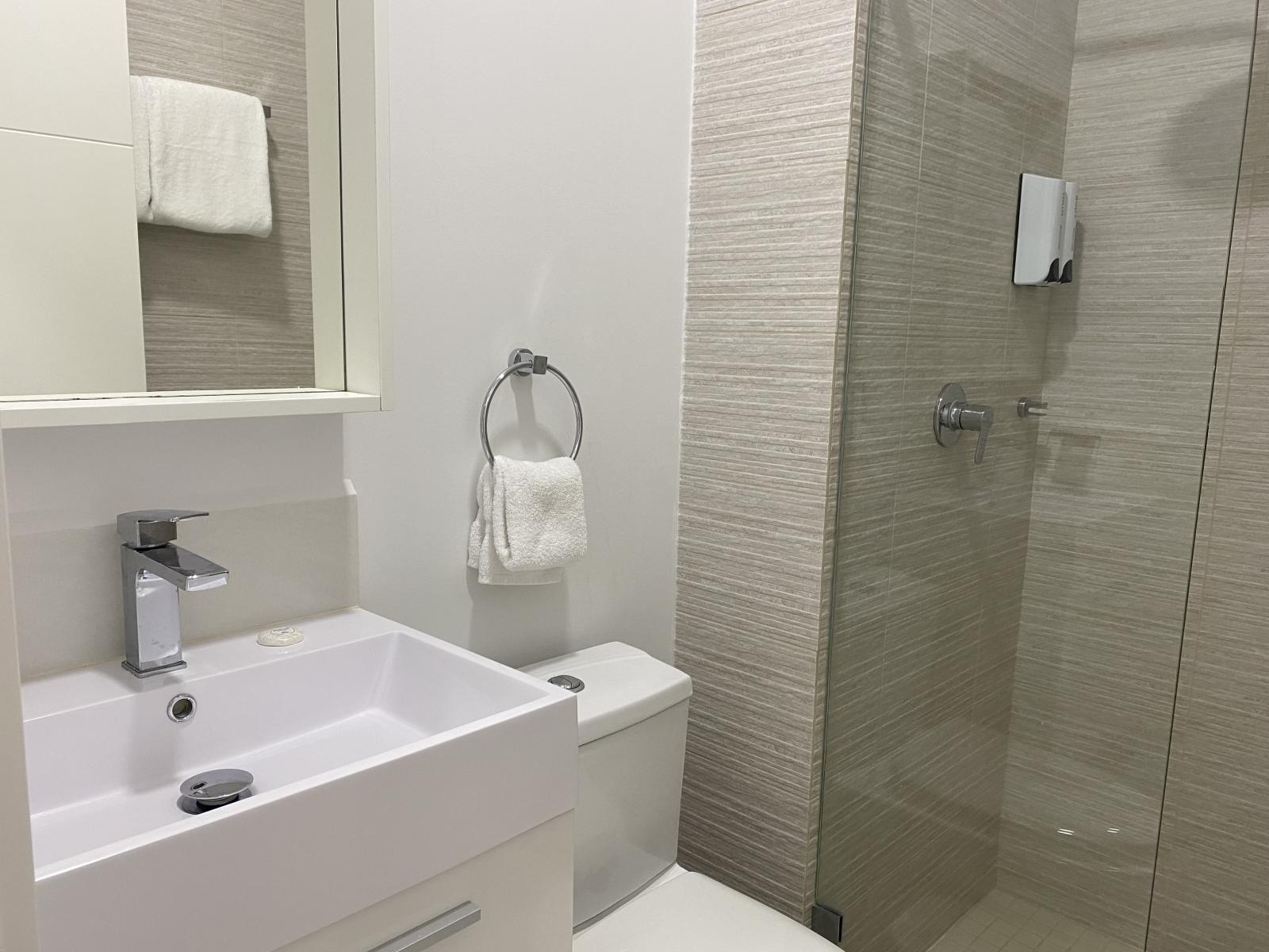 Bathroom 1 features a walk in shower and modern finishes