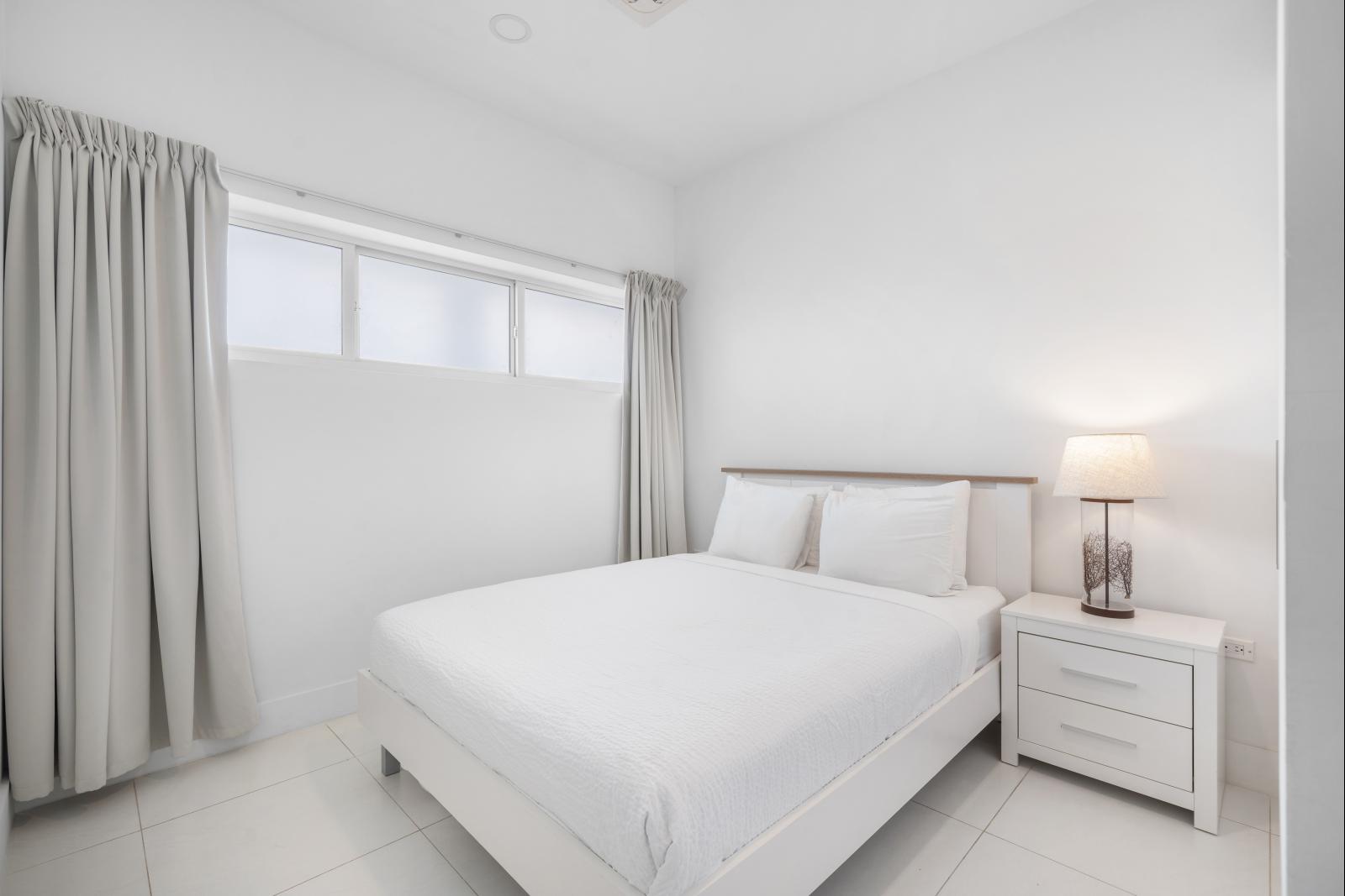 Drift off to sleep in the second bedroom with its plush bedding and serene vibe