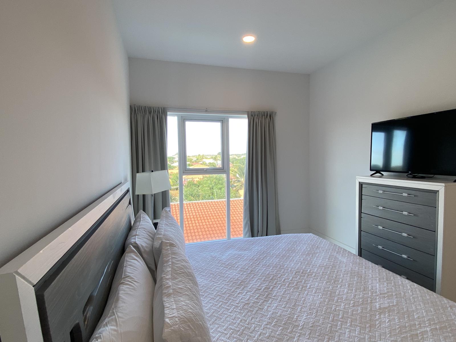 Bedroom 1 features a king size bed and plenty of natural sun light