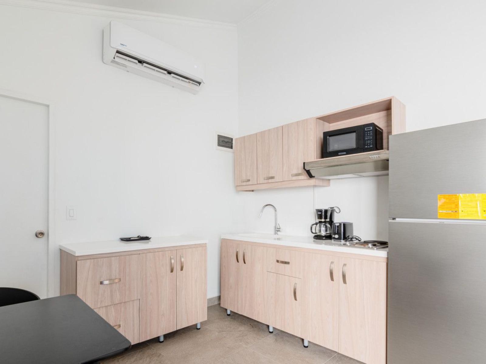 kitchenette that includes a fridge and microwave.