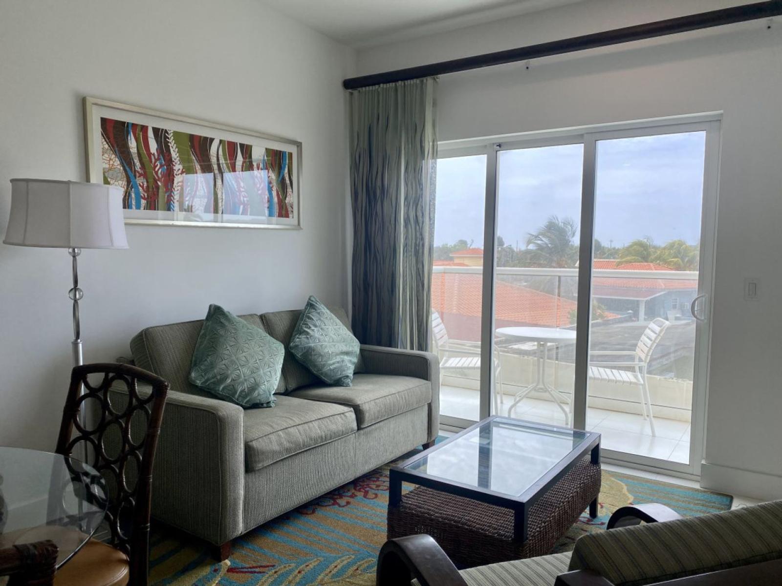 Relax in a bright, inviting living space with cozy seating and a stylish touch - Step onto the private balcony to enjoy fresh air and a peaceful view of the neighborhood - Conveniently located near beaches, dining, and attractions for a fun getaway