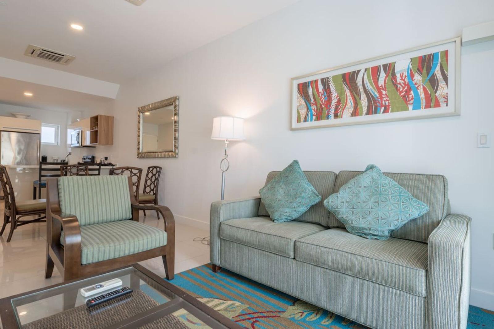 Welcoming living space with cozy seating, stylish decor, and a relaxing vibe - Sliding doors bring in Aruba’s refreshing breeze, creating a bright open space - Perfect spot to unwind after exploring Noord’s beautiful beaches and attractions