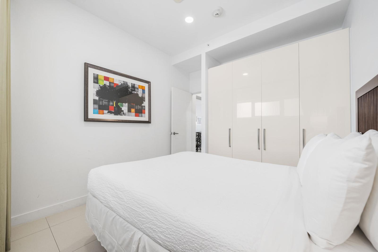 Relax deeply in this stylish king size bed, wrapped in soft, hotel quality linens - Elegant decor and warm lighting create an inviting space perfect for restful nights - Extra storage and thoughtful touches provide ultimate comfort during your stay