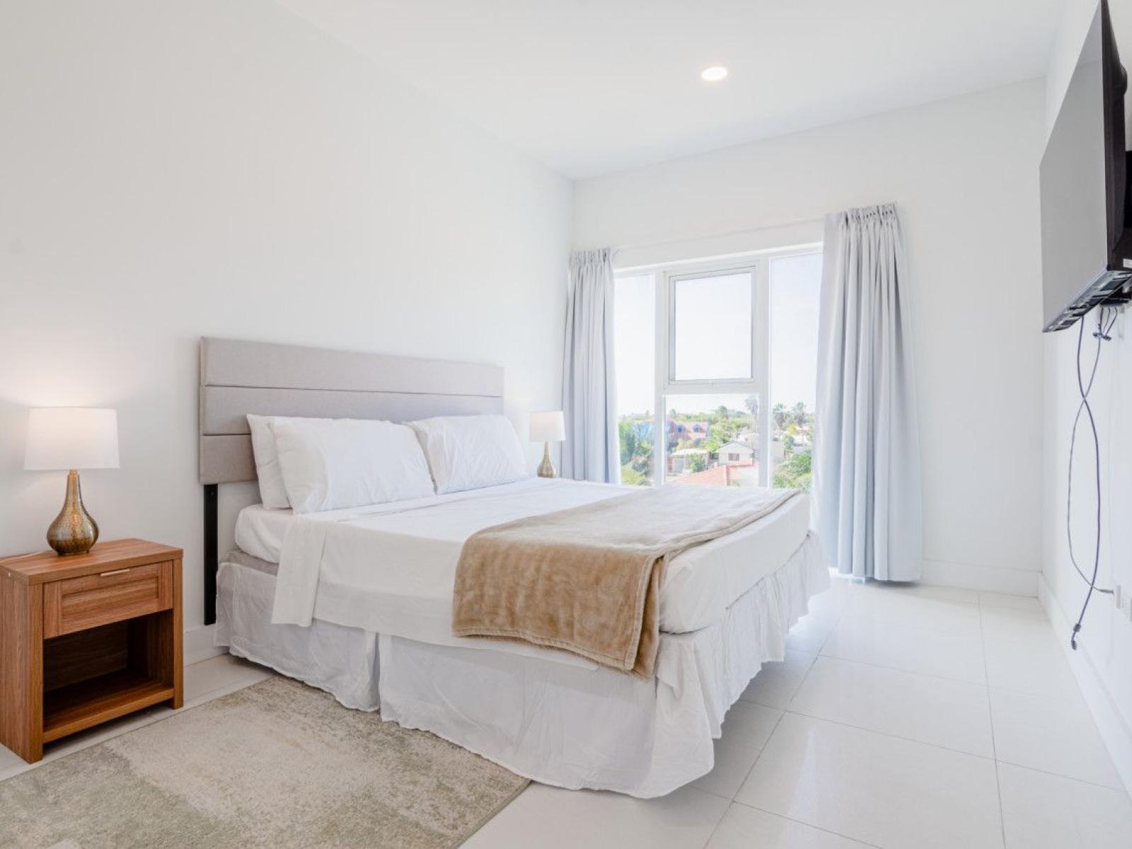 Bedroom 2 features a king size bed and big windows