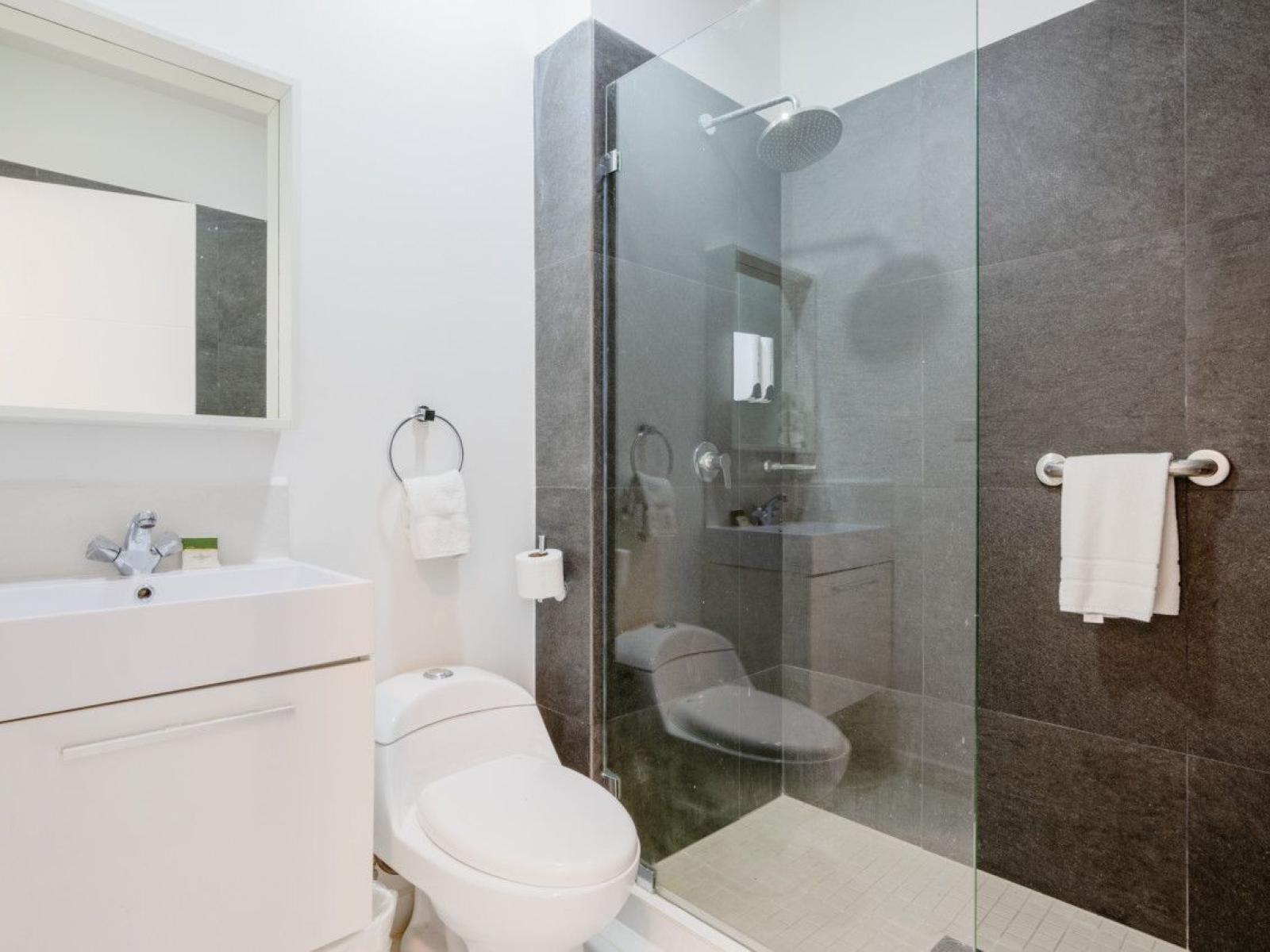 Bathroom 3 offers a walk in shower with glass door