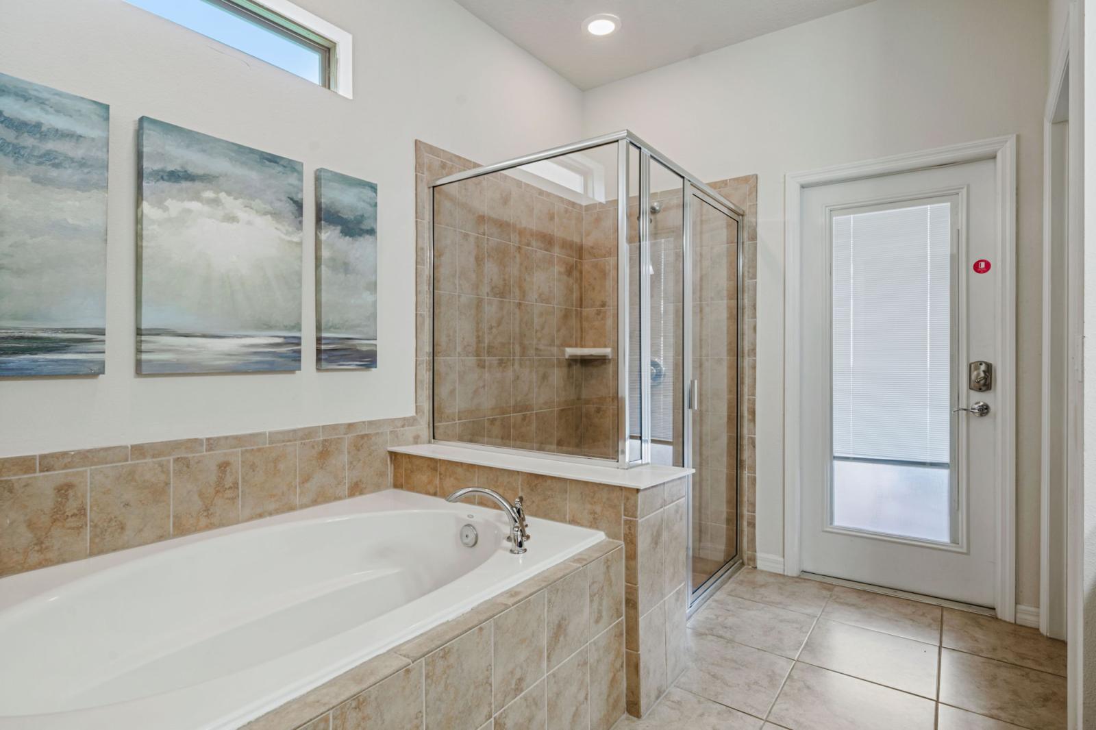 Bathroom 1 with a walk in shower and a bathtub