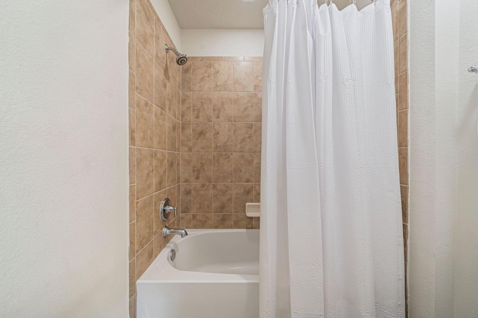 Bathroom 4 with a bathtub and shower combination