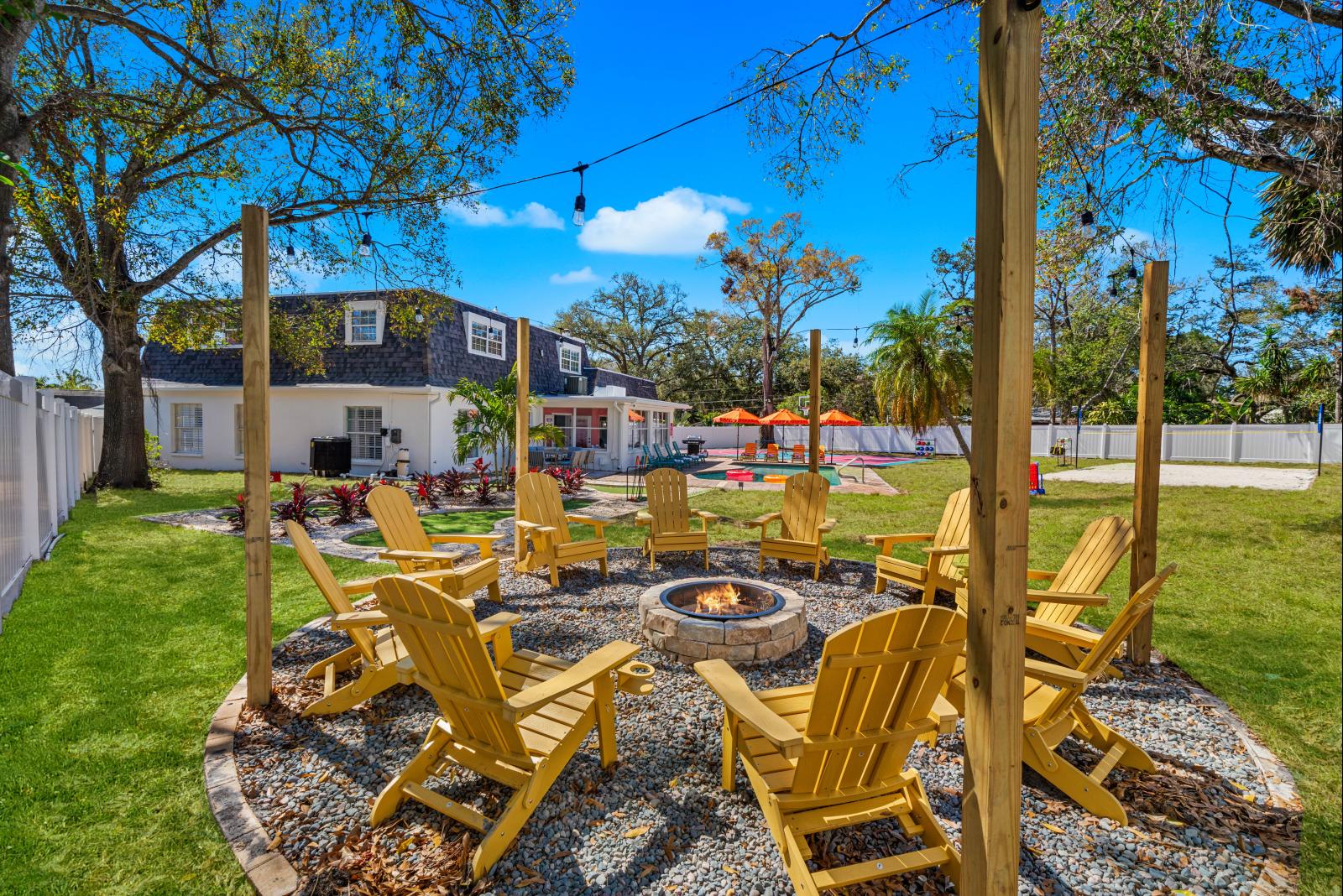 Cozy wood-burning fire pit with seating for up to 10 guests, overlooking the backyard.