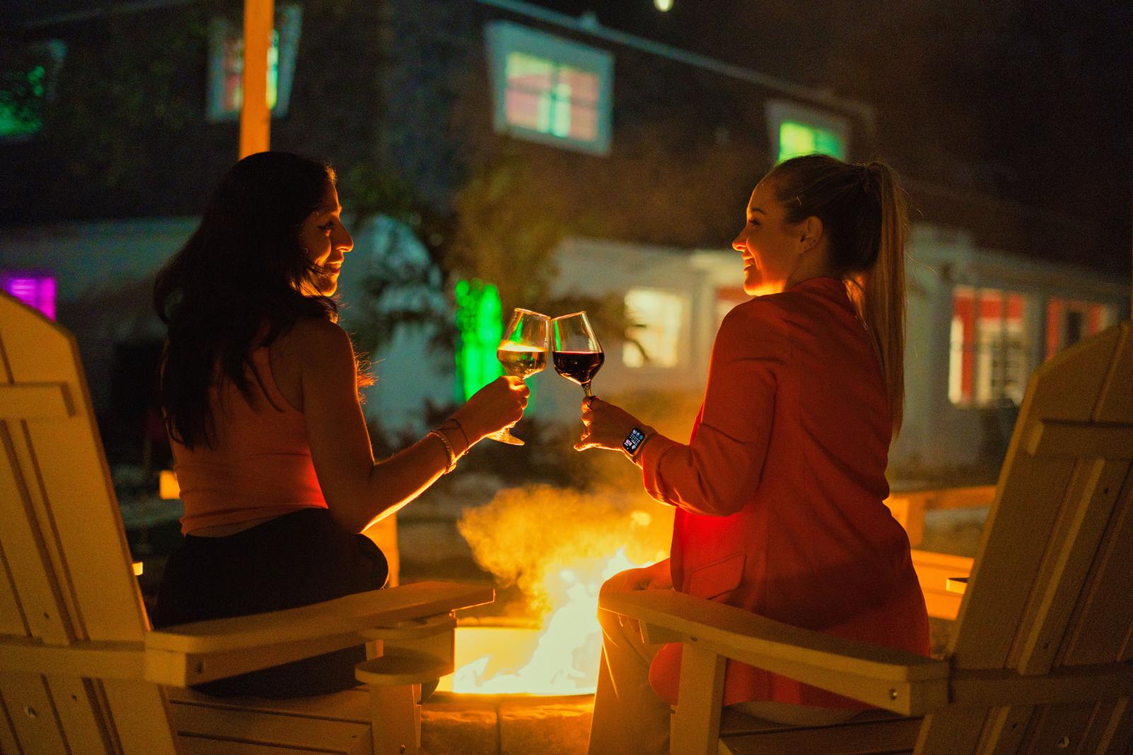 Cozy wood-burning fire pit with seating for up to 10 guests, overlooking the backyard.