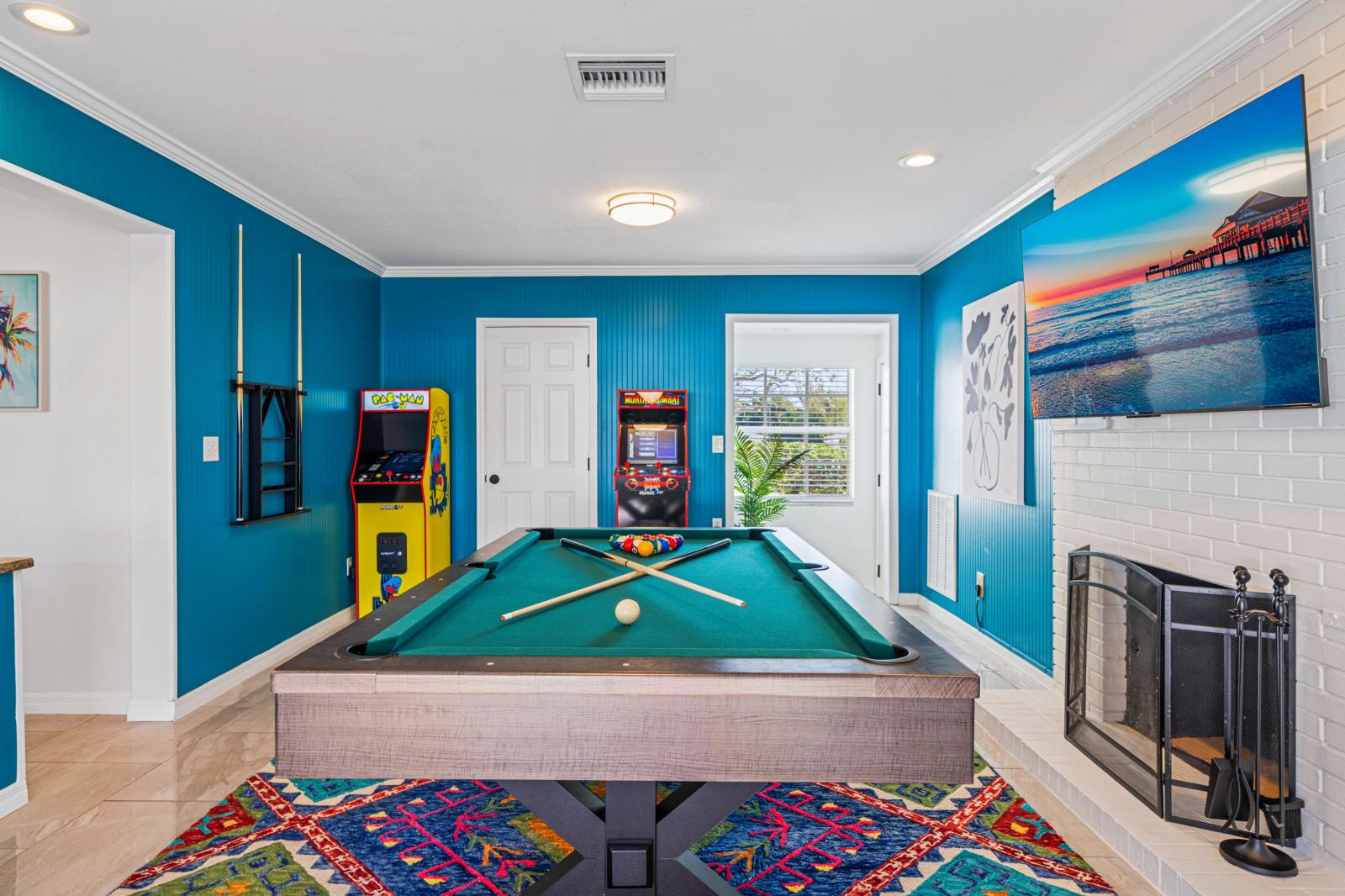 Game room featuring a snooker/pool table and a variety of exciting arcade games