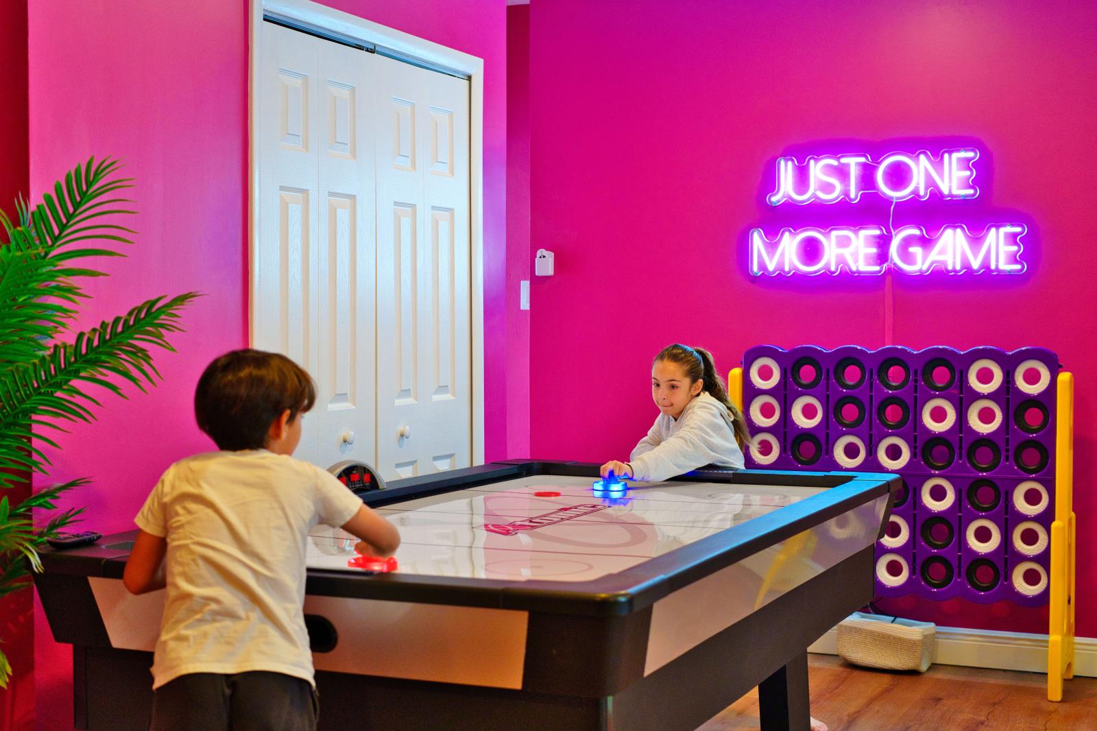 Ultimate kids' paradise featuring two double-over-double bunk beds with a slide, a fun climbing wall, an exciting air hockey table, and a thrilling basketball game!