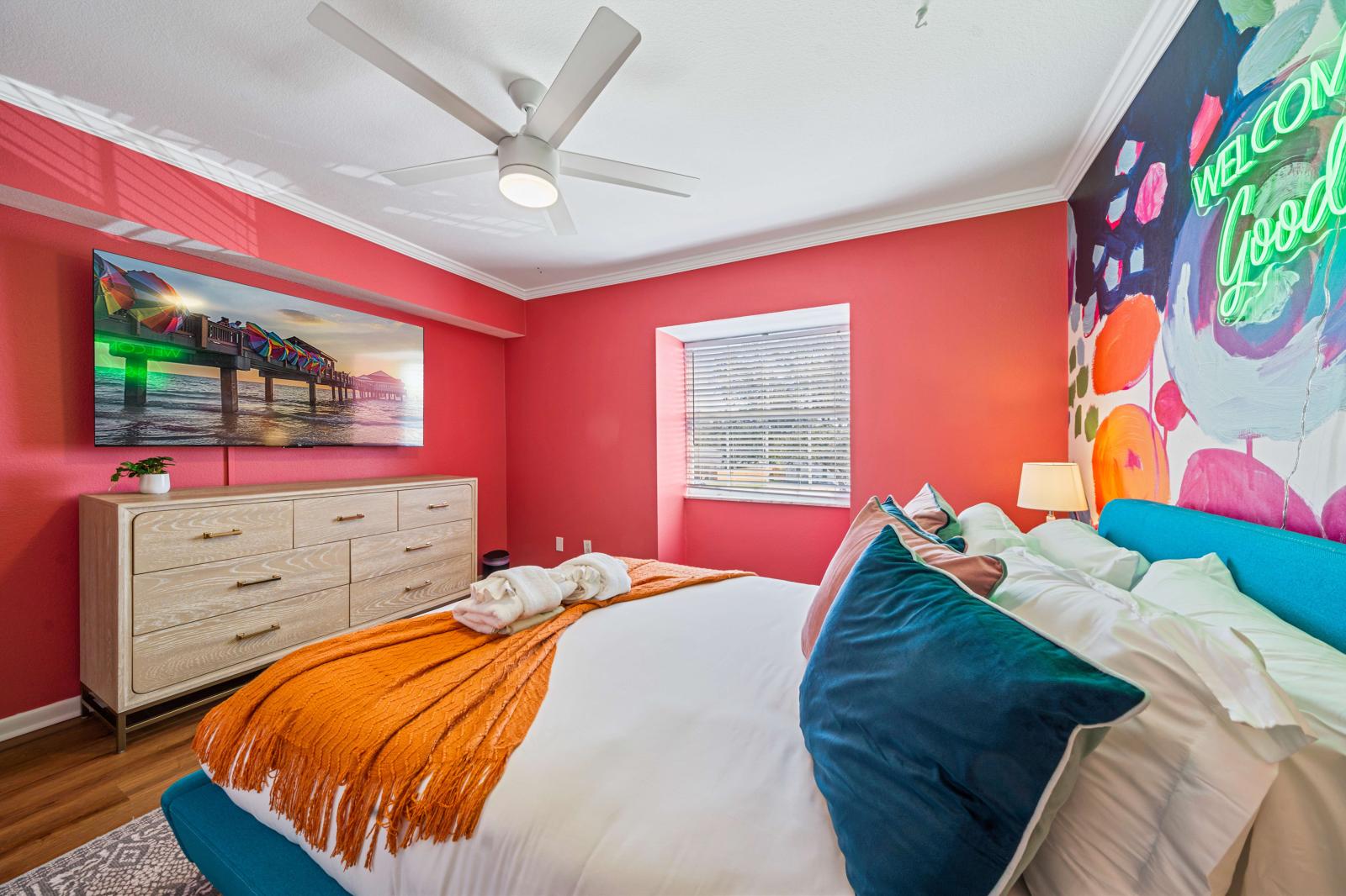 Bedroom 4: Inviting queen-size bedroom located on the second floor, featuring a refreshing ceiling fan and a large 65" smart TV for ultimate comfort and entertainment.