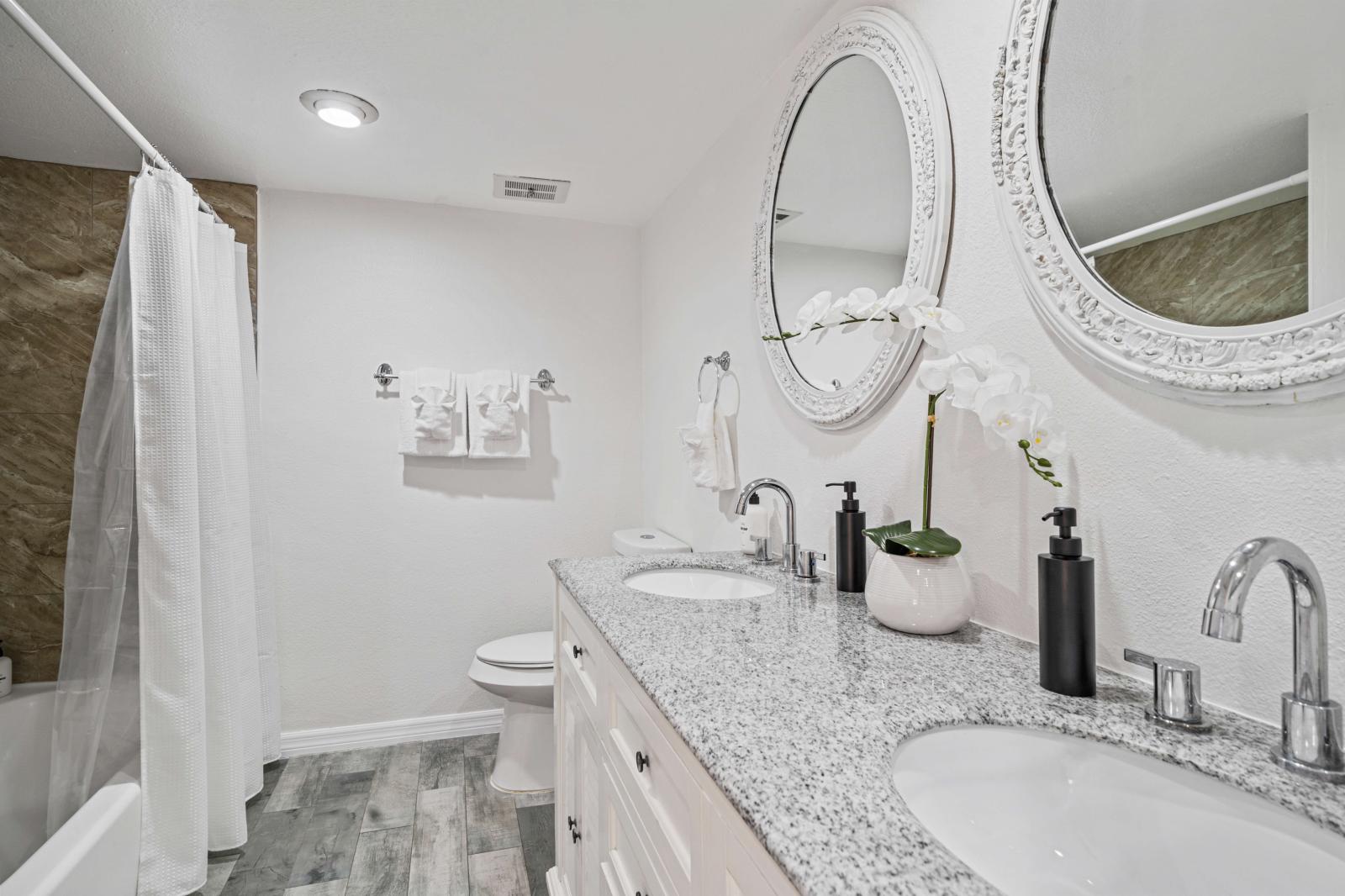 Bathroom 3: Spacious shared bathroom on the second floor, featuring a double vanity, toilet, and a convenient shower/tub combination.