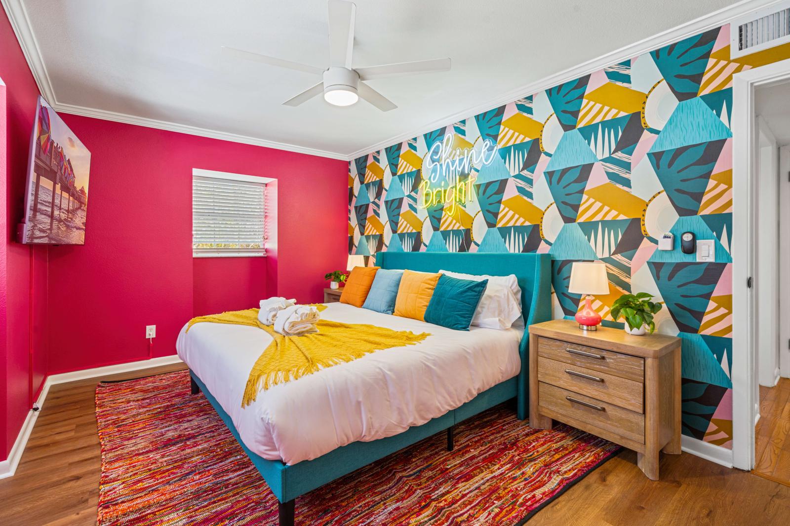 Bedroom 6: Beautifully appointed queen-size bedroom on the second floor, featuring a refreshing ceiling fan, a large 65" smart TV, and all the amenities needed for a serene and relaxing stay.