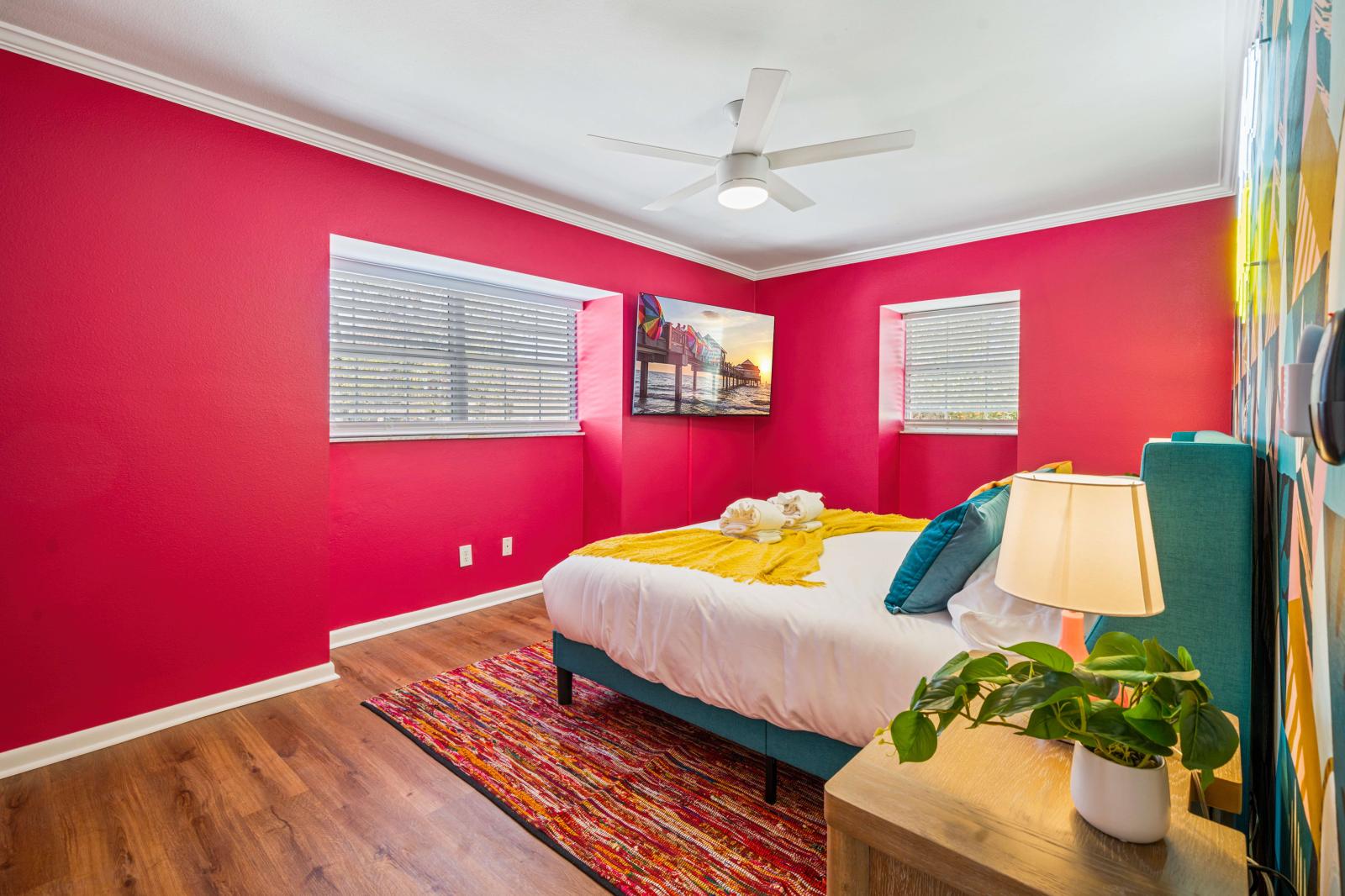 Bedroom 6: Beautifully appointed queen-size bedroom on the second floor, featuring a refreshing ceiling fan, a large 65" smart TV, and all the amenities needed for a serene and relaxing stay.