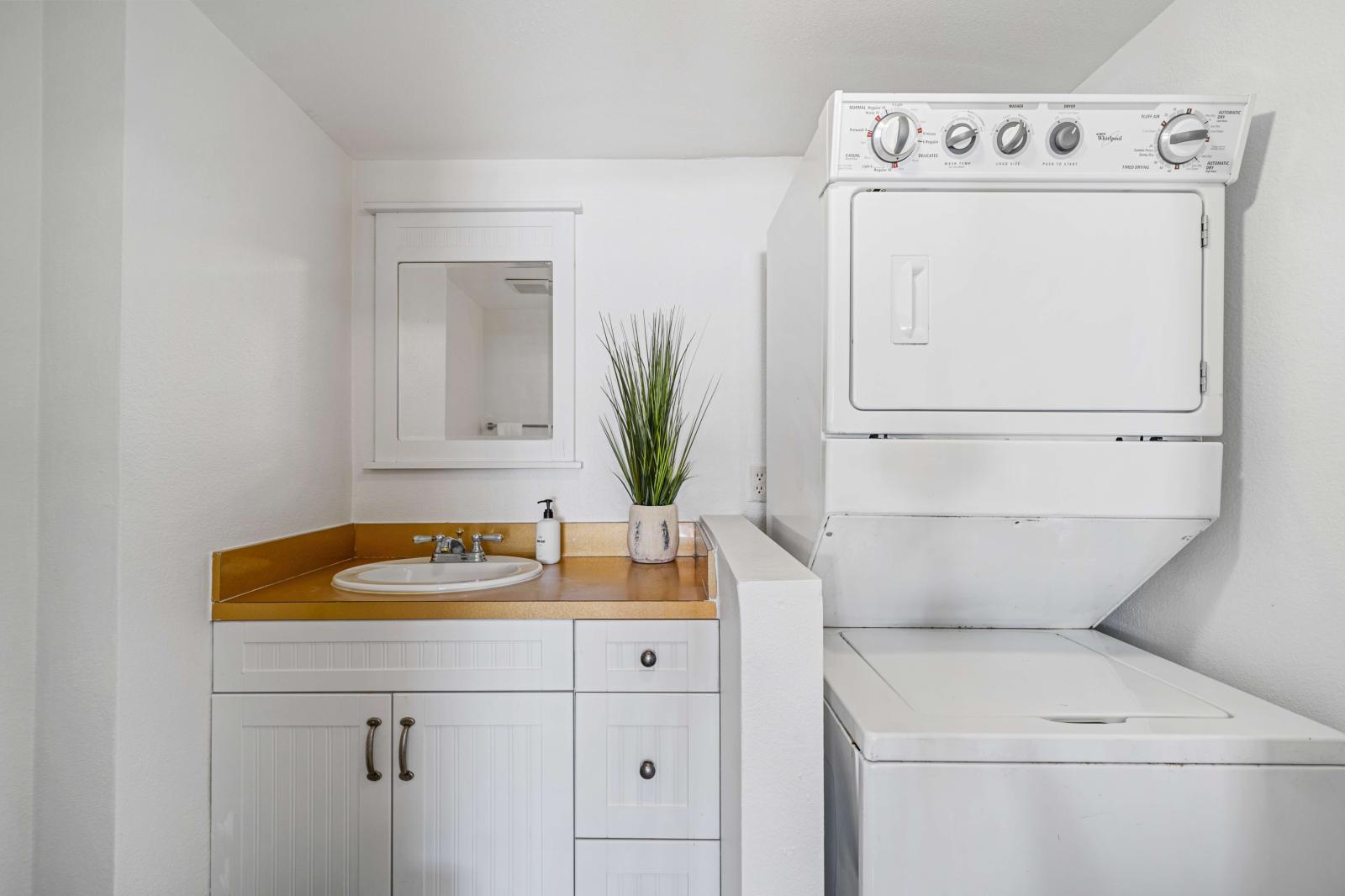 Half bathroom and laundry room with washer and dryer.