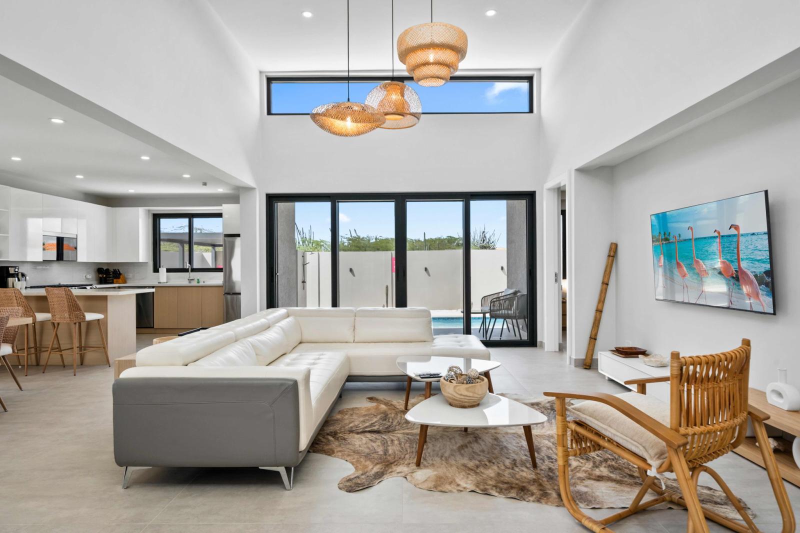 Beautifully designed living space with high ceilings & plenty of natural light - Open layout connects seamlessly to the kitchen & private pool - Kick back on the comfy sectional, stream your favorite shows, and soak up the vacation vibes