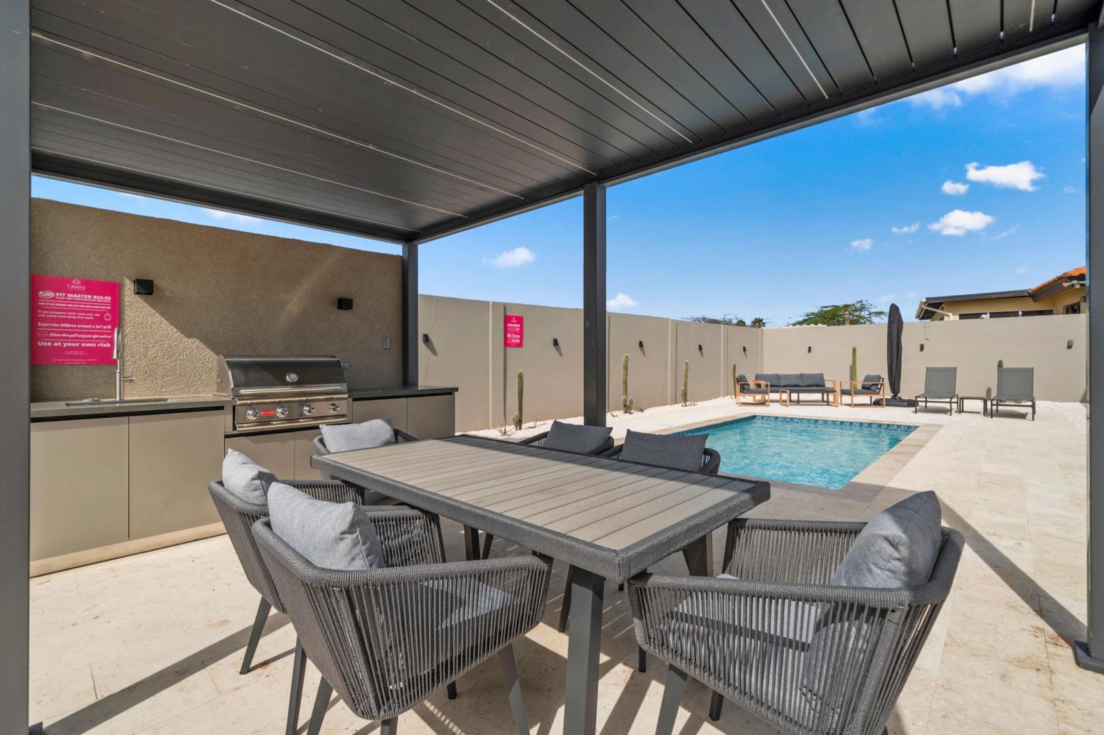 Fire up the grill & enjoy poolside dining in this shaded outdoor retreat - Cozy seating, a sleek dining table & a BBQ setup make it perfect for any meal - Whether it’s a sunny brunch or a starlit feast, this space is made for unforgettable moments