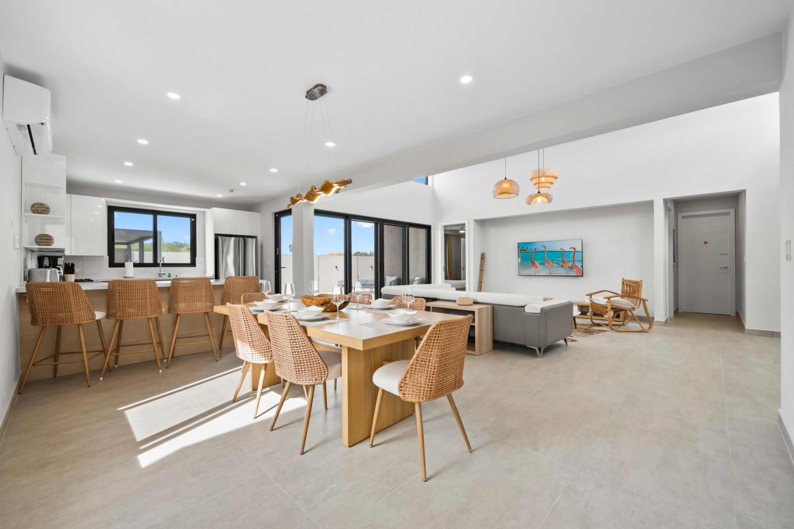 Spacious open concept living with a dining area, modern kitchen & cozy seating - Bright interiors with natural light, stylish décor & seamless indoor outdoor flow - Perfect for gatherings, with a well-equipped kitchen & comfortable dining setup