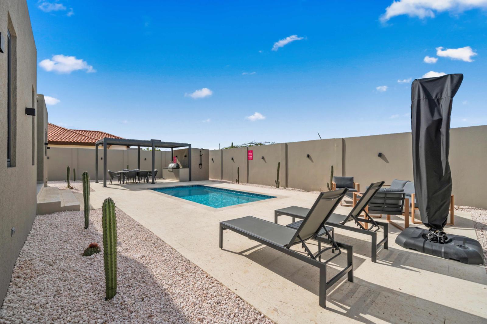 In the backyard you will find a refreshing pool with plenty of lounge chairs to soak up the sun