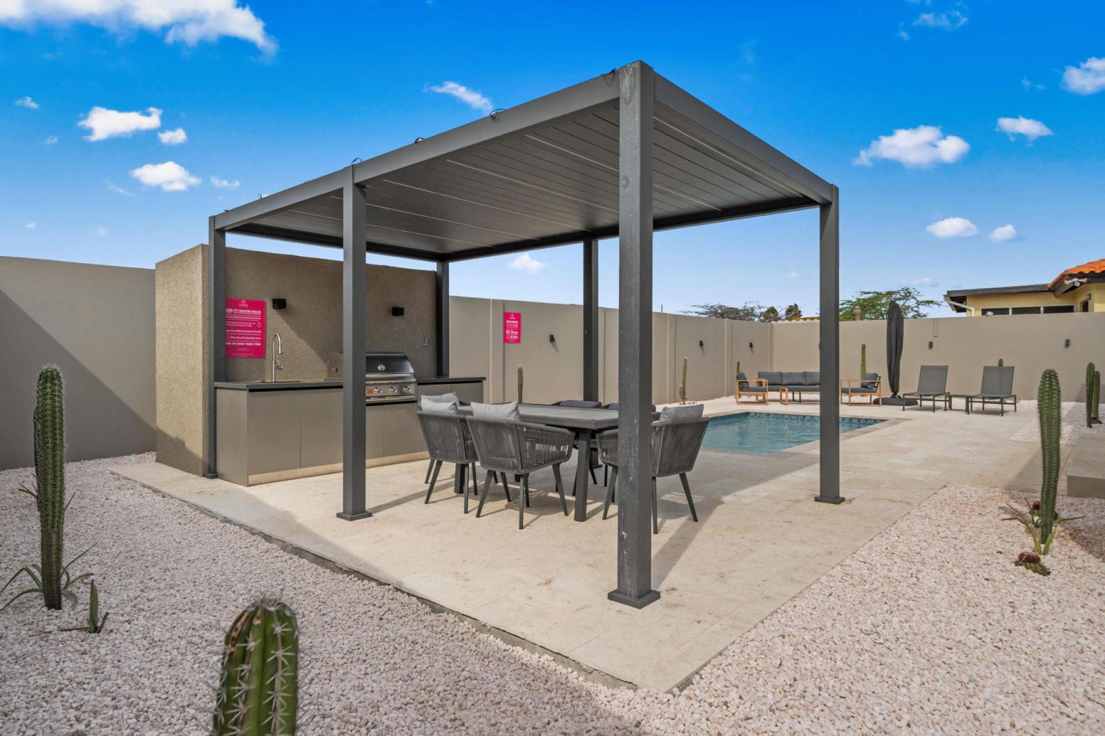 Fire up the BBQ grill and enjoy alfresco dining in this shaded outdoor seating area - Perfect spot to gather, share meals, and make memories under the Aruba sky - A seamless blend of comfort and style, designed for relaxed outdoor living