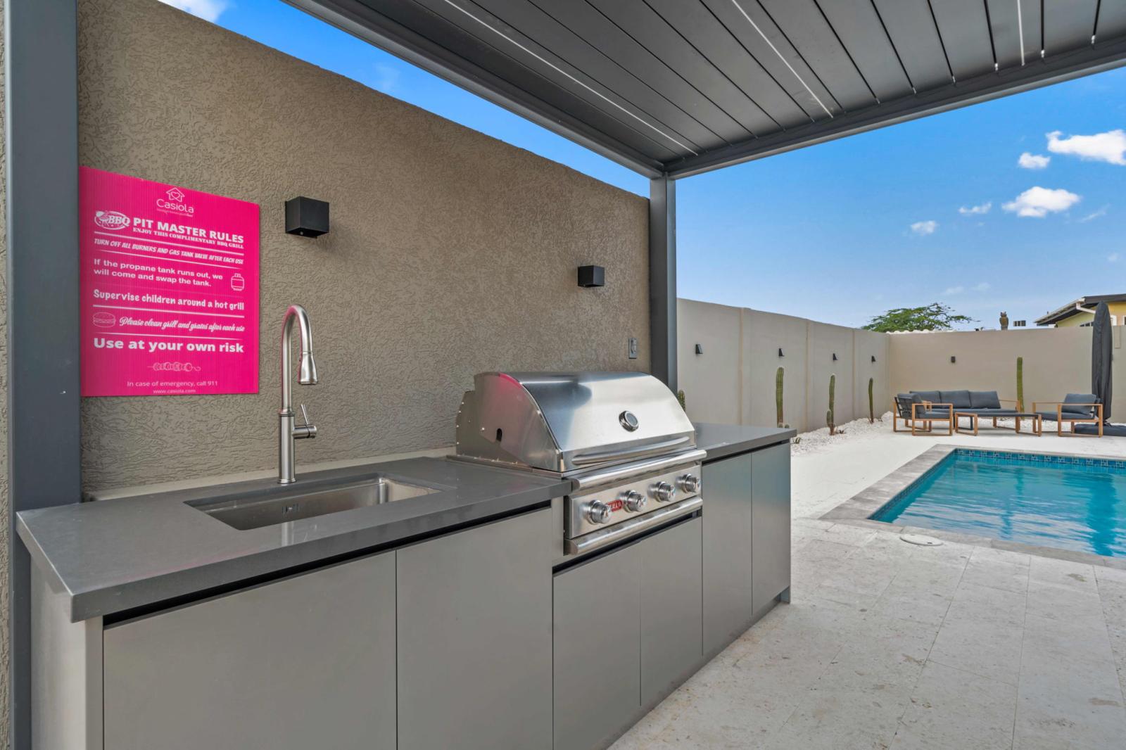 Fire up the built-in BBQ & enjoy grilling by the pool in your private outdoor kitchen - Spacious, shaded setup with a sink & prep area makes outdoor cooking effortless - Gather, grill, and dine under the open sky for a true island-style experience