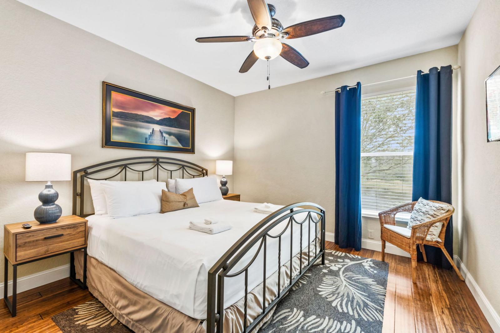 Primary Bedroom with king-size bed, smart-TV, ceiling fan and walk-in closet