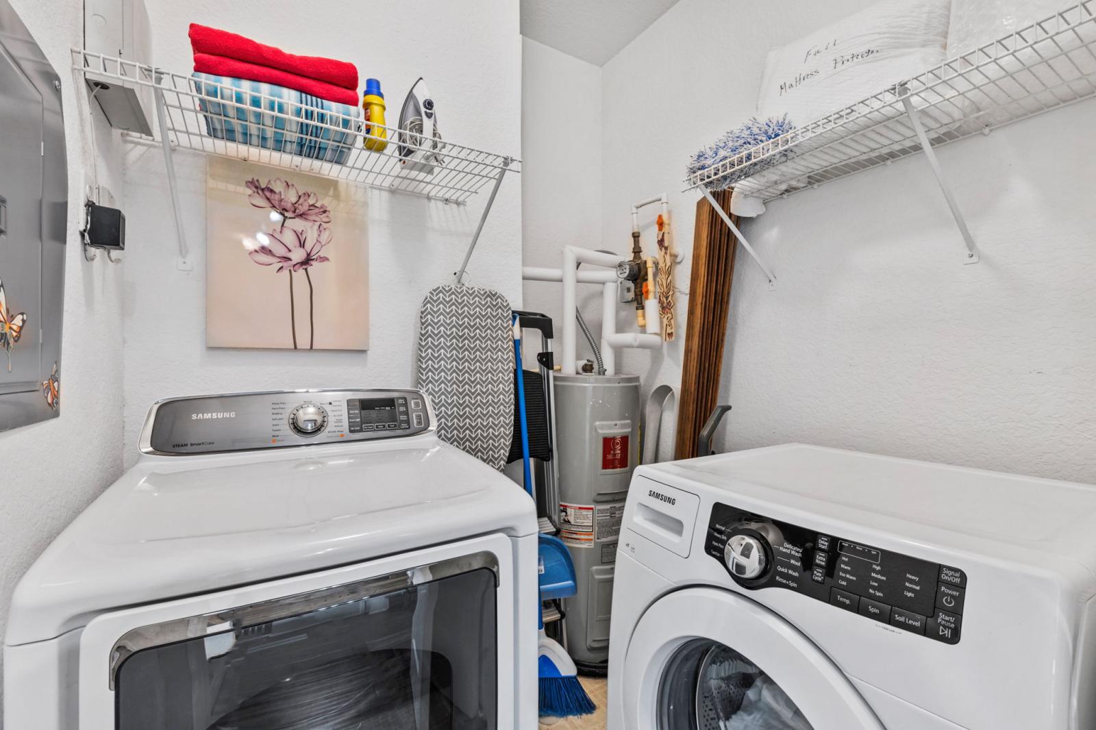 A separate laundry room is fully equipped with the essentials to meet all of your laundry needs, or to provide a pressed look for a night out.