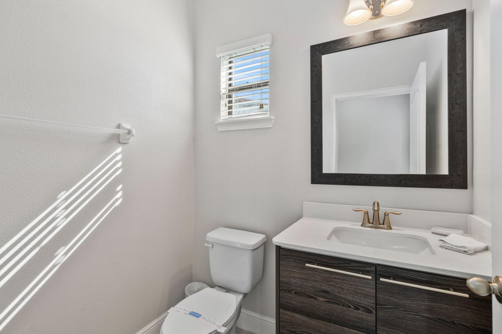 Convenient Half Bath! Located on the 1st floor, this half bathroom features a toilet and single sink for easy access and added convenience.